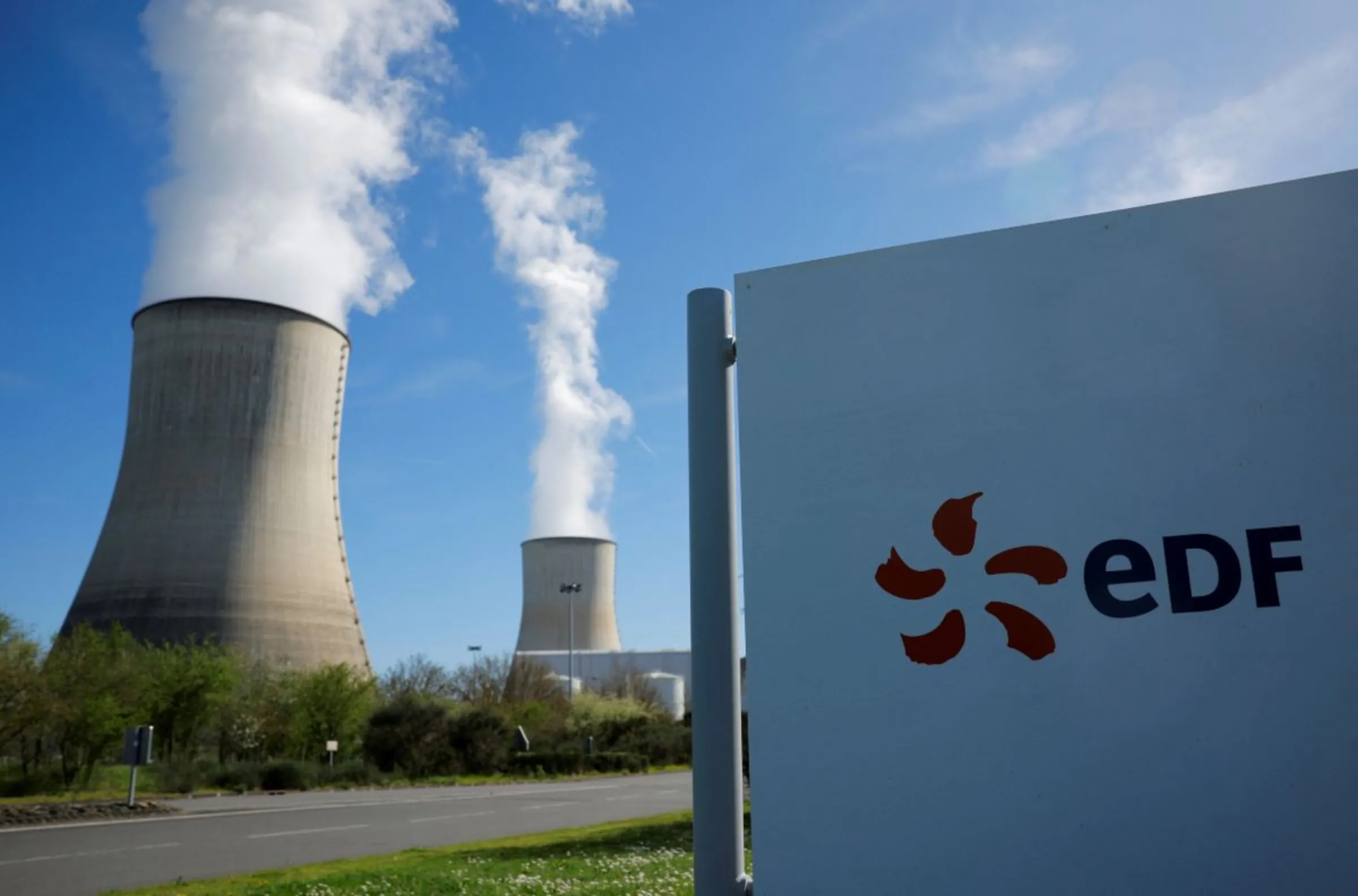 The logo of Electricite de France (EDF) is seen in front of cooling towers at the entrance of the nuclear power plant site, in Civaux, France, March 19, 2024. REUTERS/Stephane Mahe