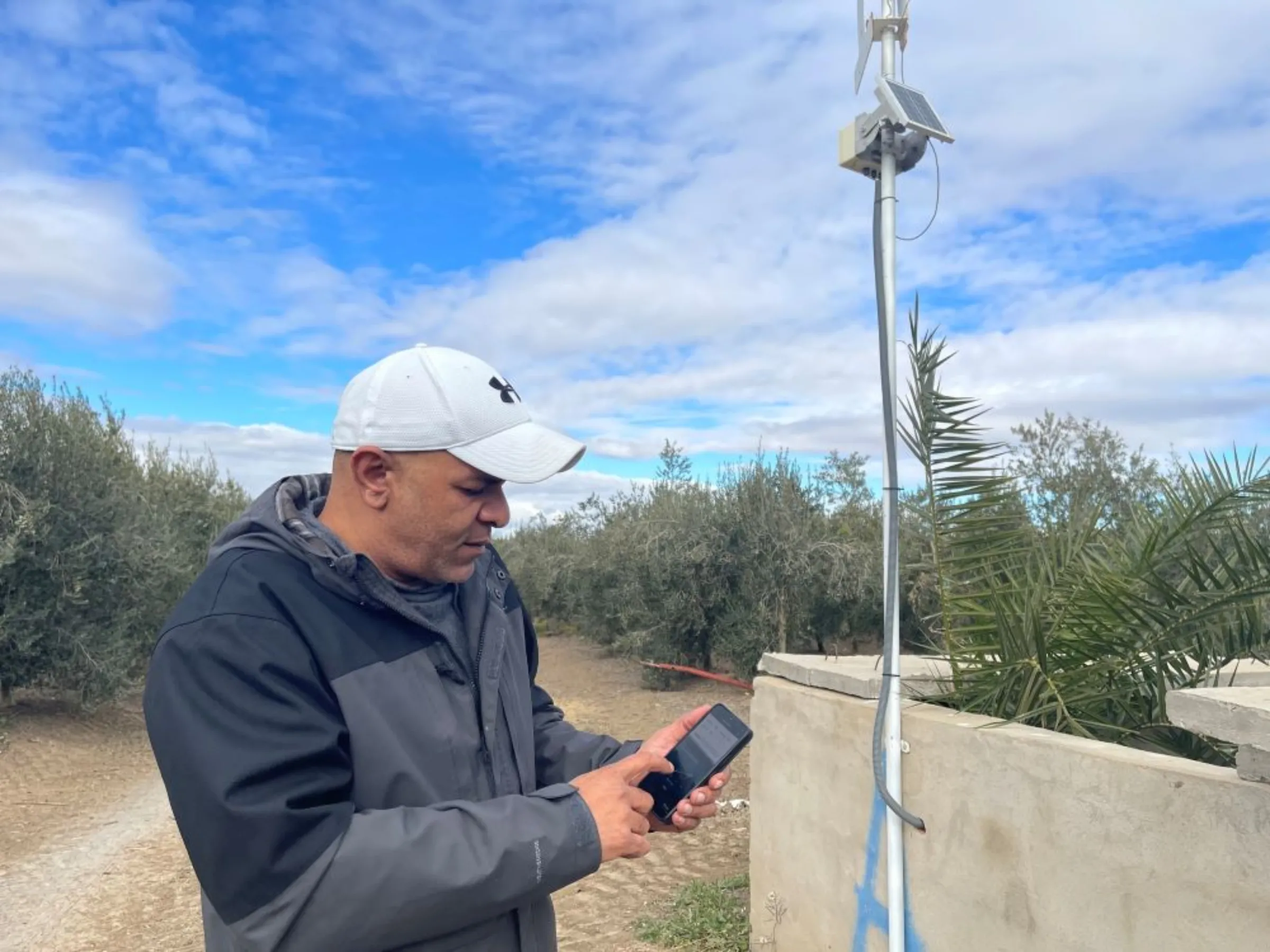 Yasser Bououd, co-founder of Ezzayra, manages the irrigation system on a farm northeastern Tunisia through a mobile app, January 30, 2023