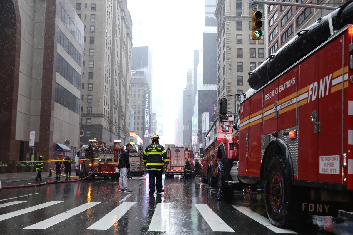New York City Fire Department trucks and firefighters are seen outside 787 7th Avenue in midtown Manhattan where a helicopter was reported to have crashed in New York City, New York, U.S., June 10, 2019. REUTERS/Brendan McDermid