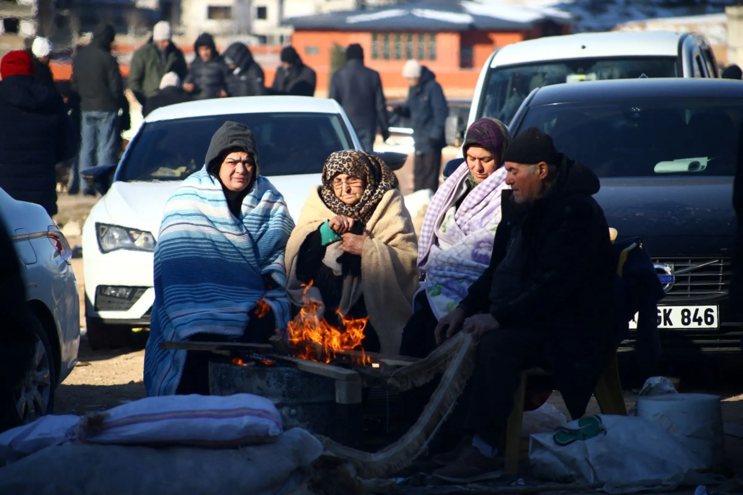 People wait near the site of a collapsed building in the aftermath of a deadly earthquake in Gaziantep, Turkey February 9, 2023. REUTERS/Cagla Gurdogan