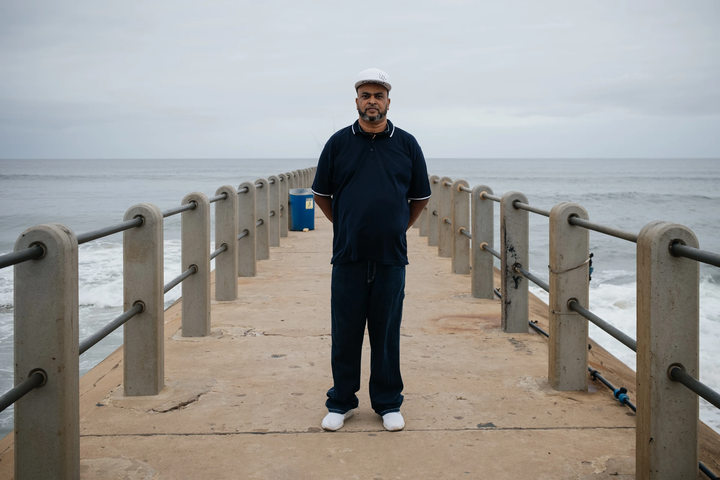 Subsistence anglers look for a catch at Snakepark Pier on the beachfront in Durban, South Africa, April 1, 2021. They fear warming oceans, sea level rise and decreases in the diversity of fish species will hit their catch. Thomson Reuters Foundation/James Puttick