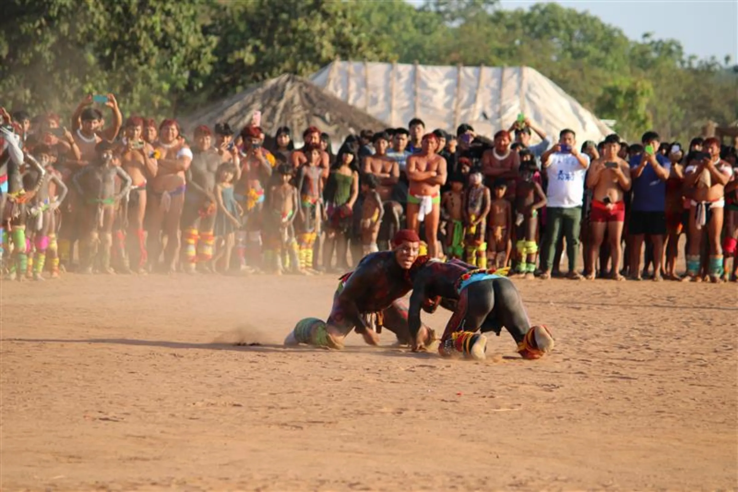 Men wrestle “huka-huka” during the Kuarup funerary ritual in the Kalapalo people’s Tanguro village, Xingu Indigenous Park, Brazil, August 31, 2025. THOMSON REUTERS FOUNDATION/André Cabette Fábio
