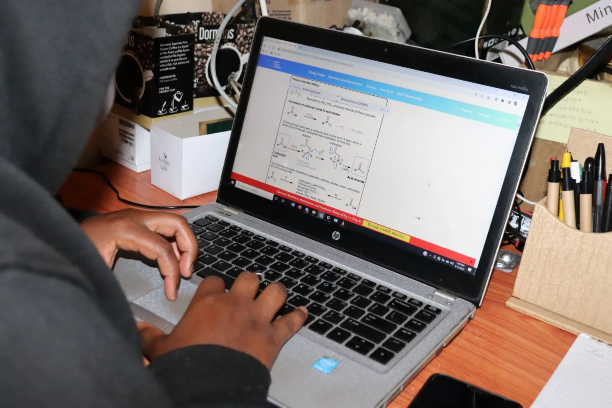 Laura working on an assignment at her house in Nairobi, Kenya, May 17, 2023. Thomson Reuters Foundation/Dominic Kirui