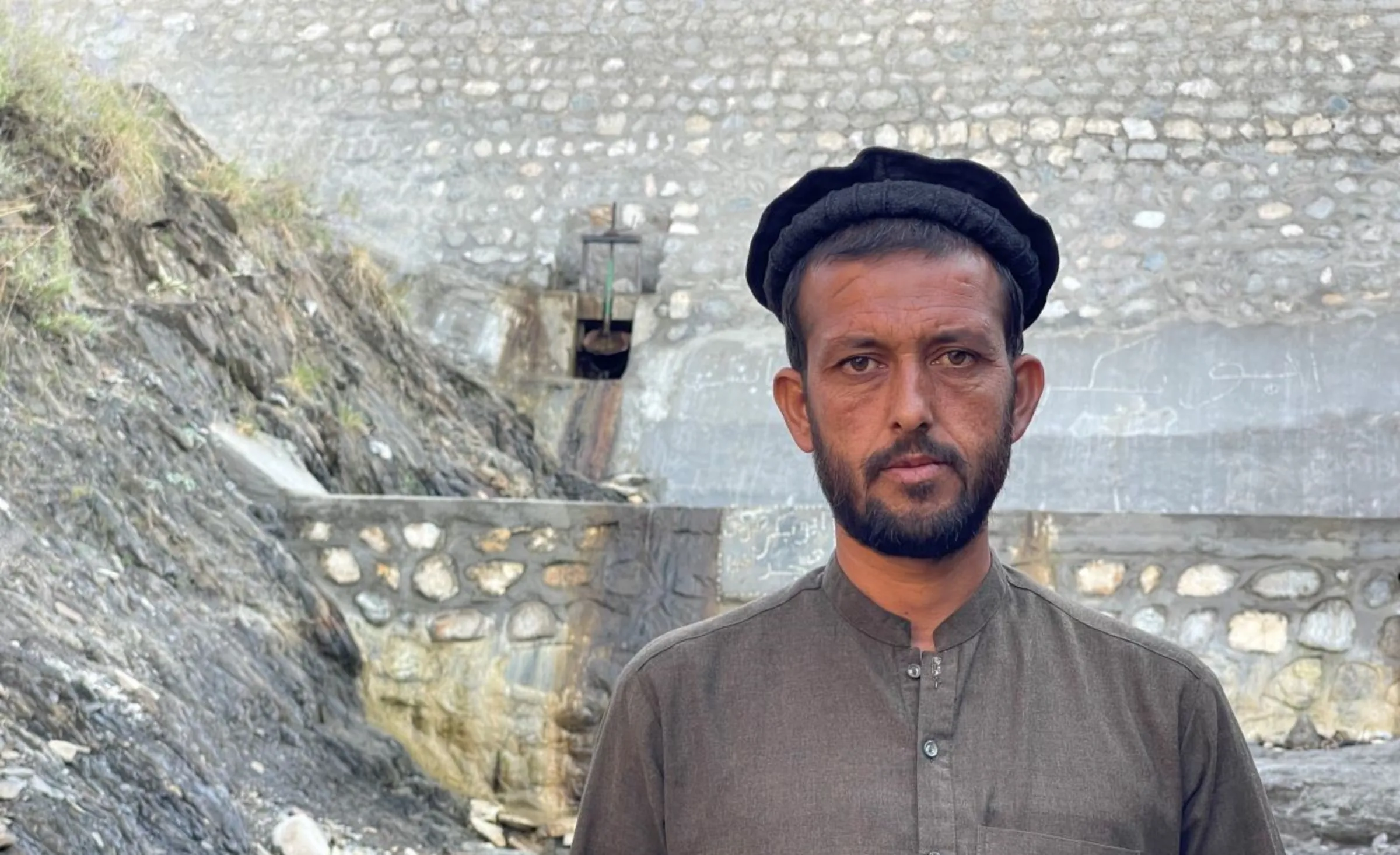 Farmer Hazratullah is seen near a dam in Haska Mina in Nangarhar province, east Afghanistan, October 2023