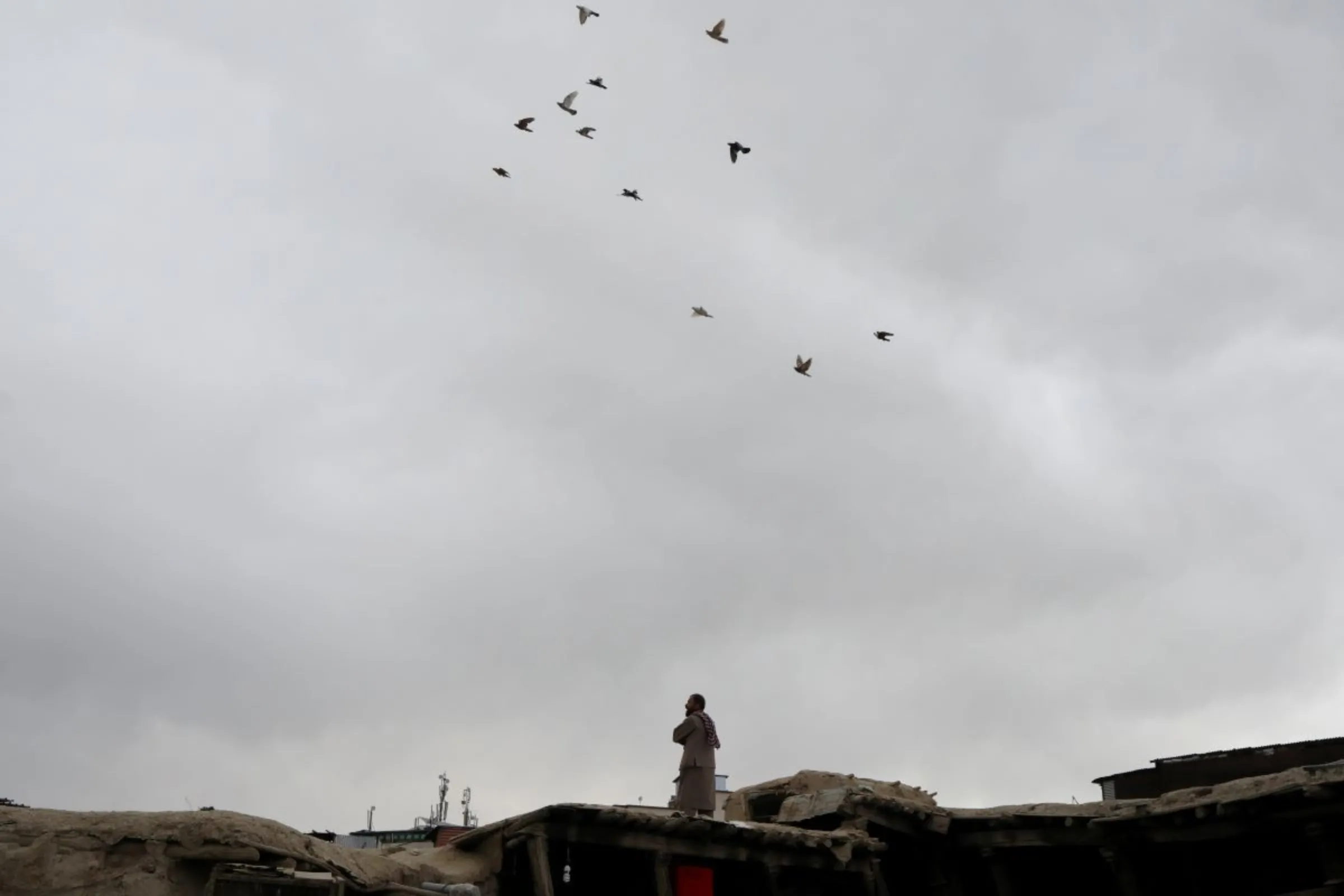 An Afghan man stands on a rooftop in Kabul, Afghanistan, April 22, 2022. REUTERS/Ali Khara