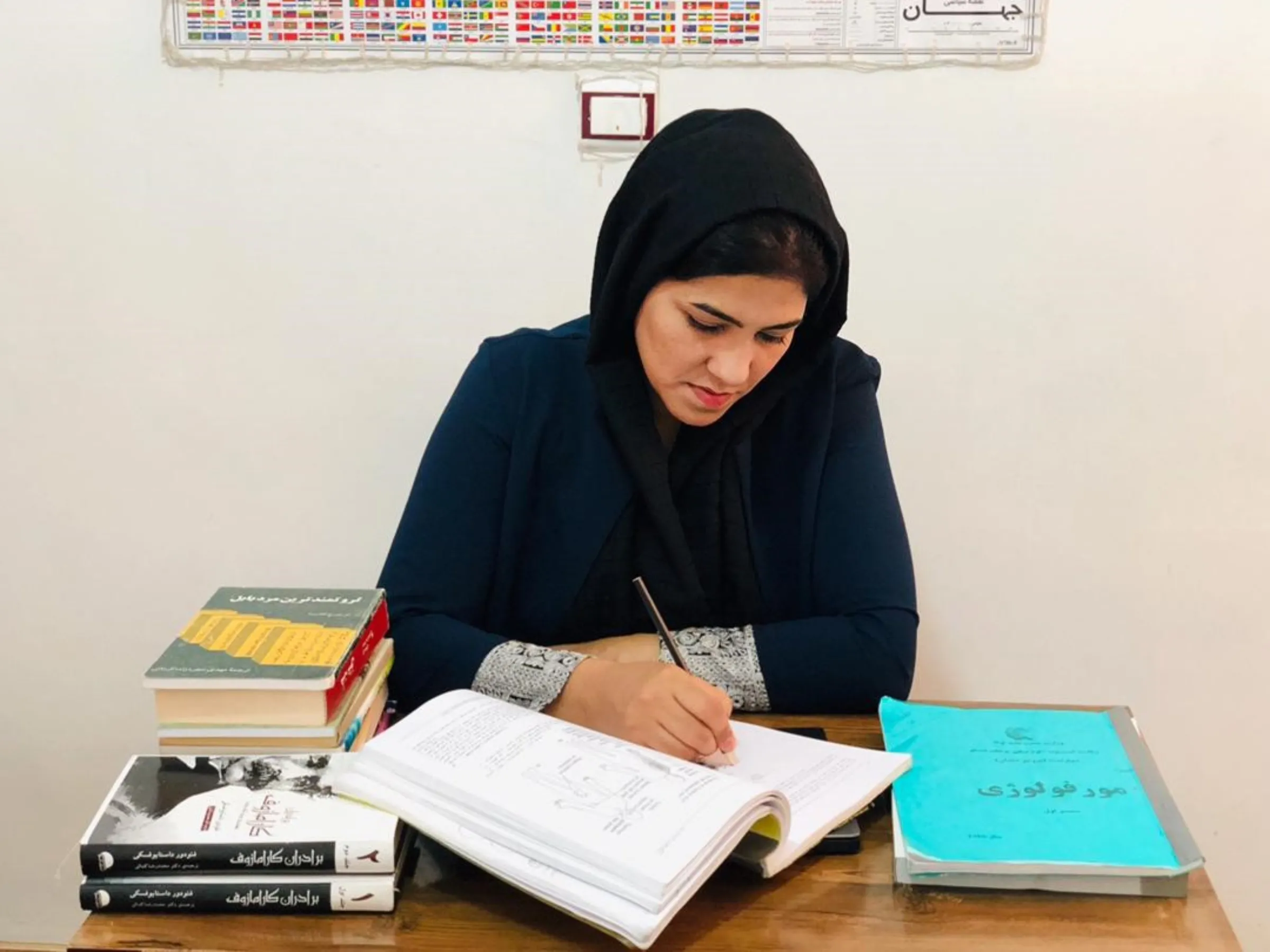 Former university lecturer and faculty dean Shabana Sediqian prepares for her nursing course at her home in Herat, Afghanistan. Photo taken August 2023