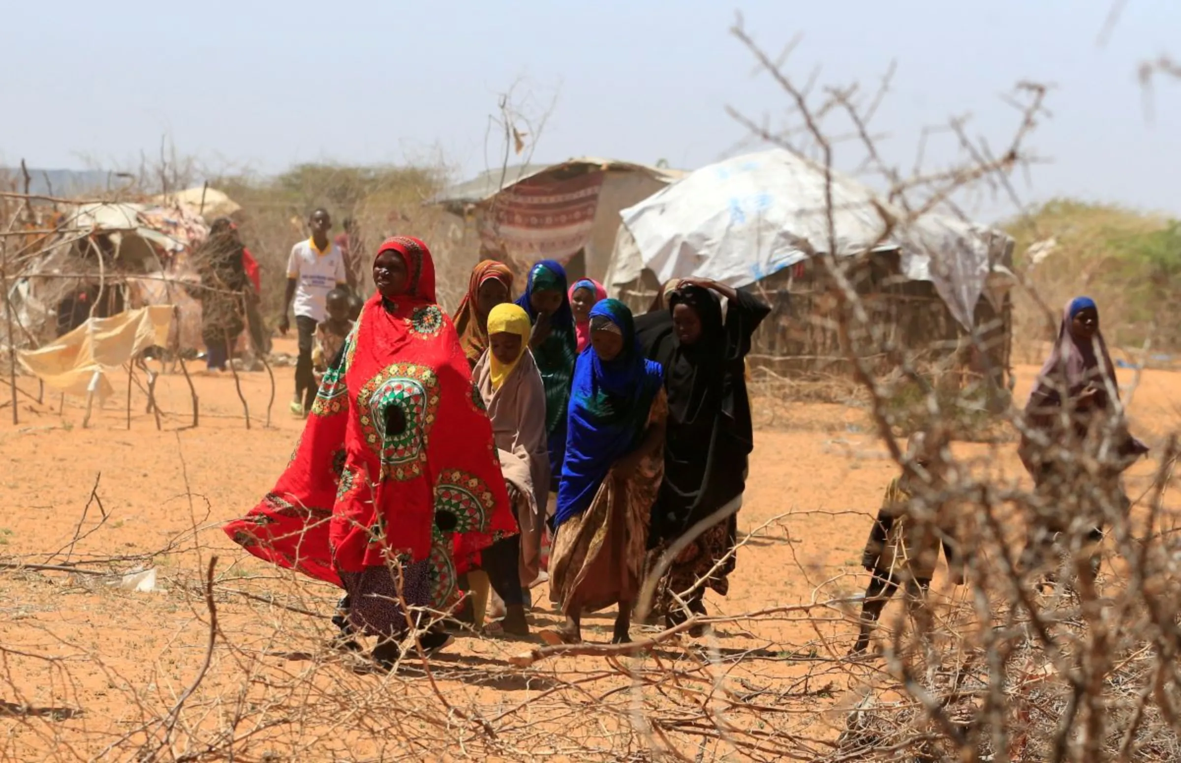 Somali refugees walk outside their makeshift shelters in the new arrivals area at the Hagadera refugee camp in Dadaab, near the Kenya-Somalia border, in Garissa County, Kenya, January 17, 2023. REUTERS/Thomas Mukoya