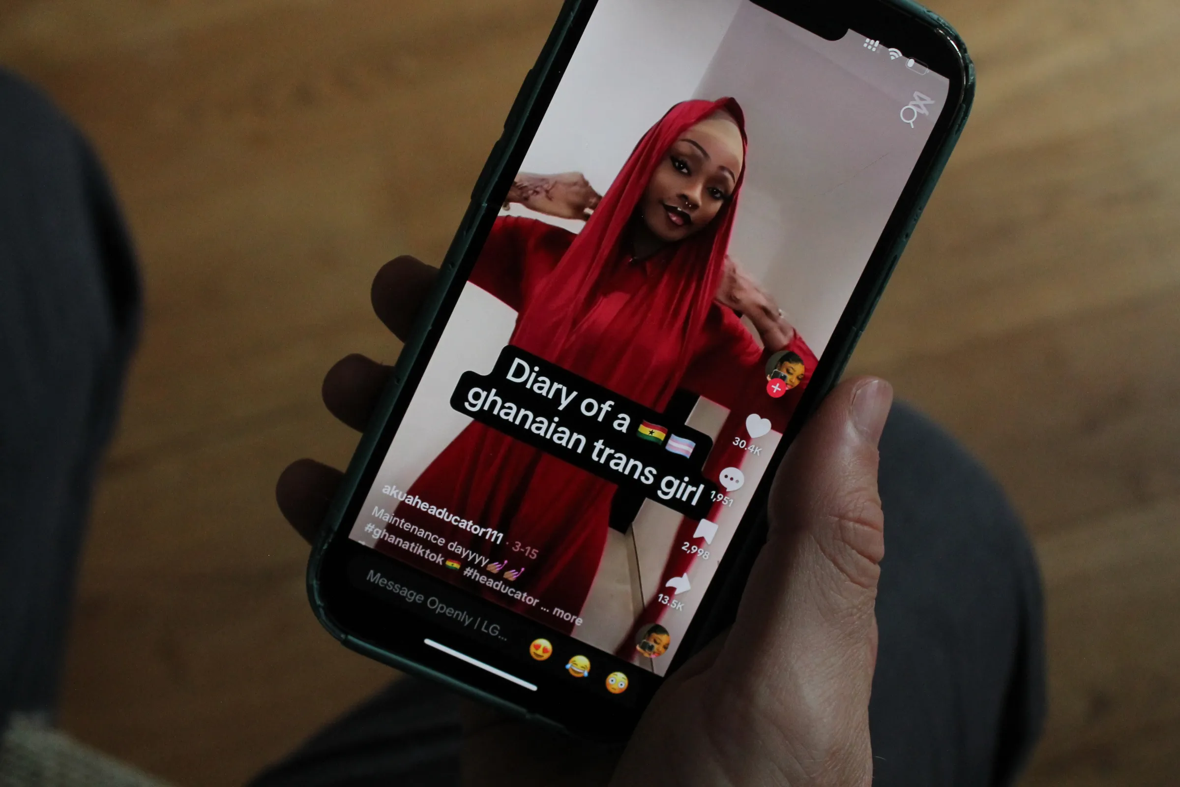 A TikTok user watches a video of Giselle, 21, an openly trans woman and content creator in Ghana. Thomson Reuters Foundation/Enrique Anarte