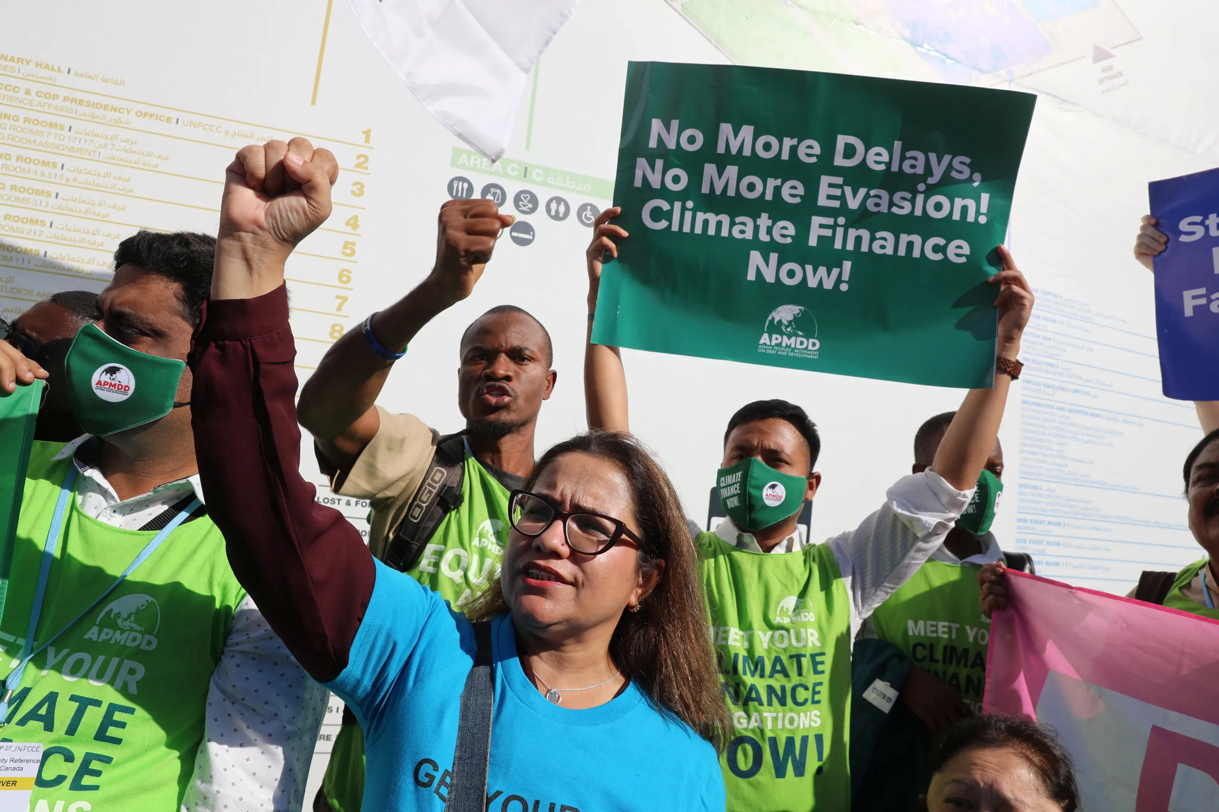 Activists hold banners as they demonstrate at the Sharm El Sheikh International Convention Centre, during the COP27 climate summit, in Sharm el-Sheikh, Egypt, November 9, 2022