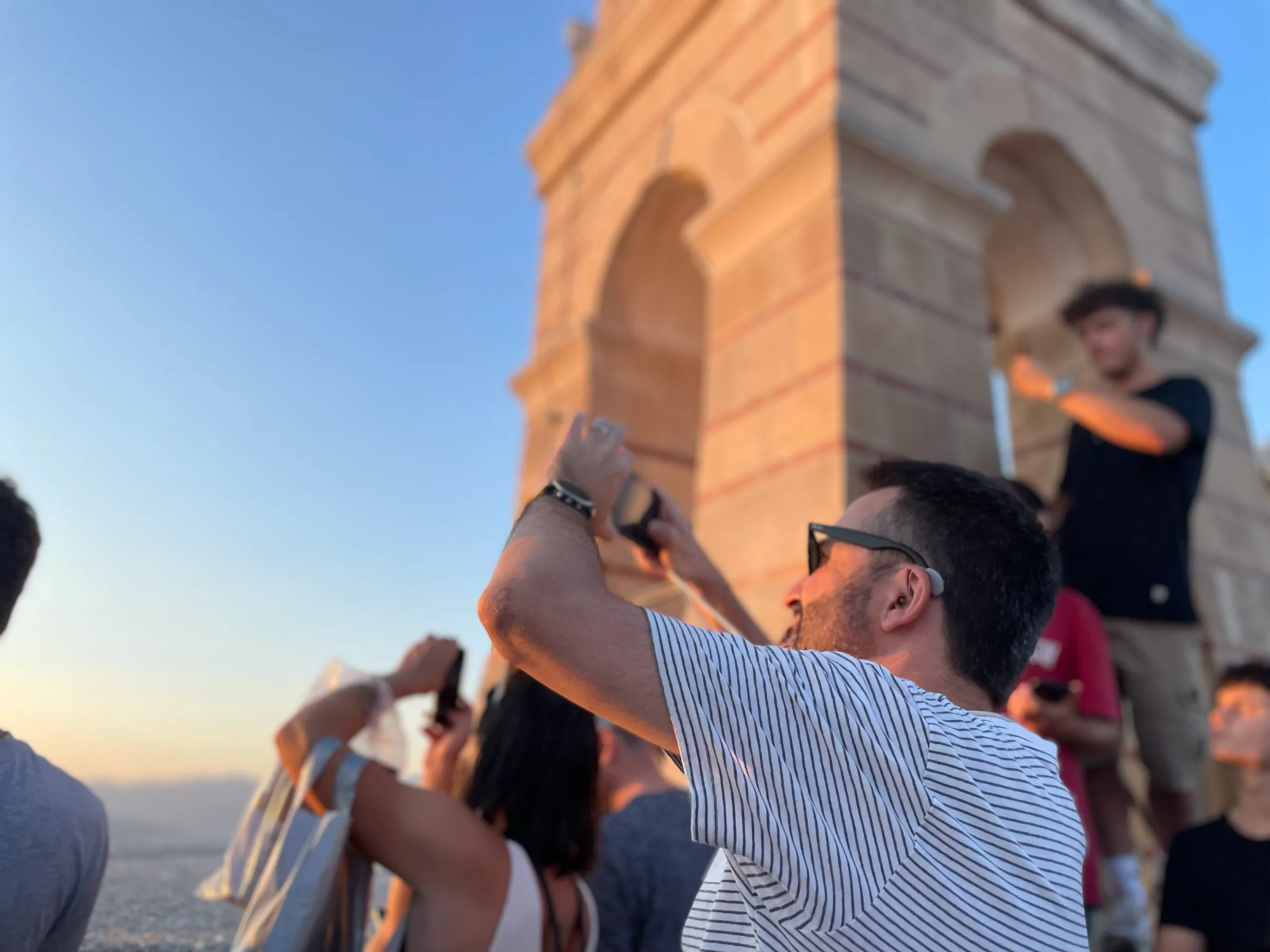 Tourists take pictures of the view at sunset from the top of Lycabettus hill, Athens, Greece. July 30, 2024. Thomson Reuters Foundation/Beatrice Tridimas