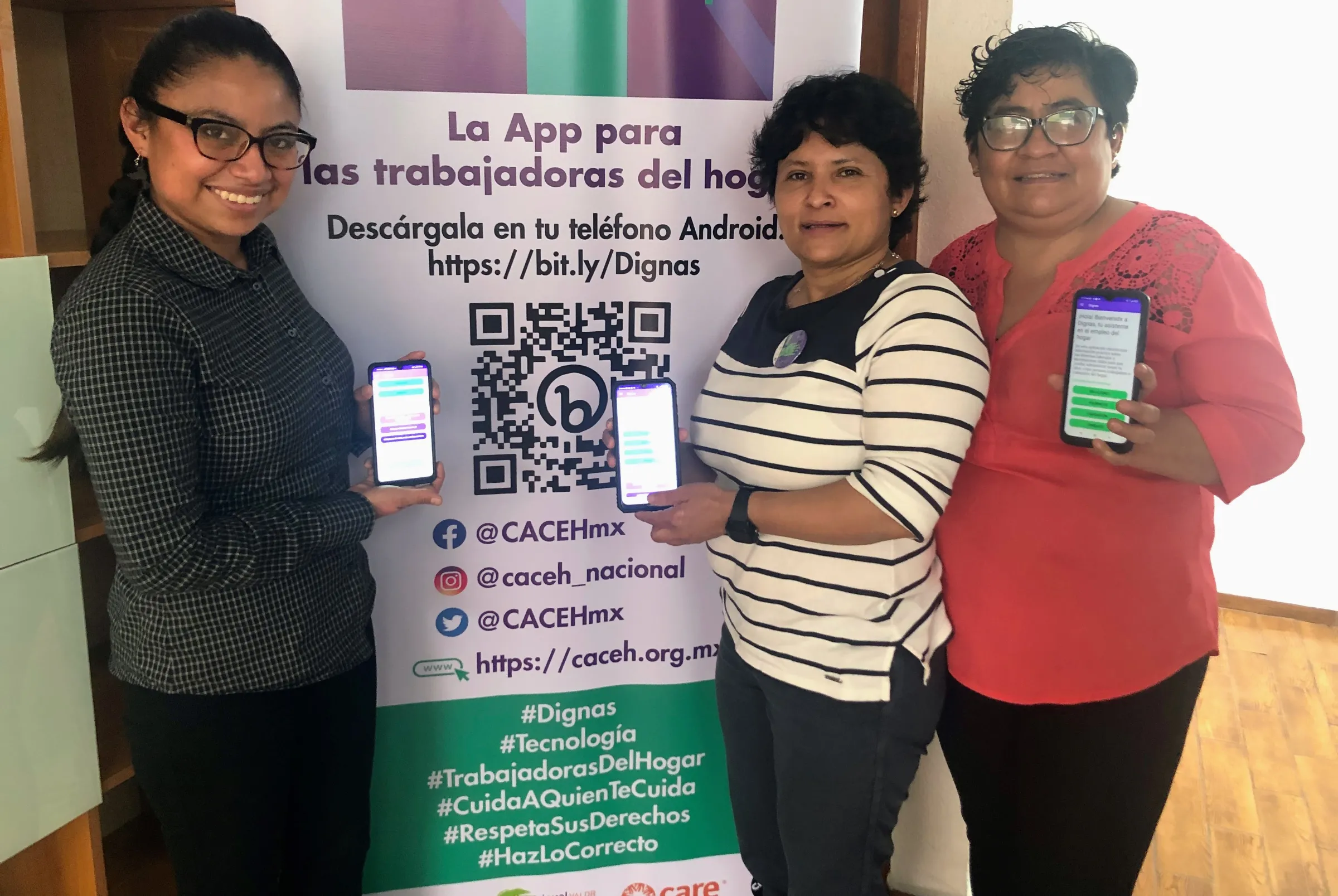 Ana Sofia Pablo, Nancy Rojas and Diana Enriquez, members of nonprofit CACEH, show the app Dignas on their phones at their office in Mexico City, August 19, 2022