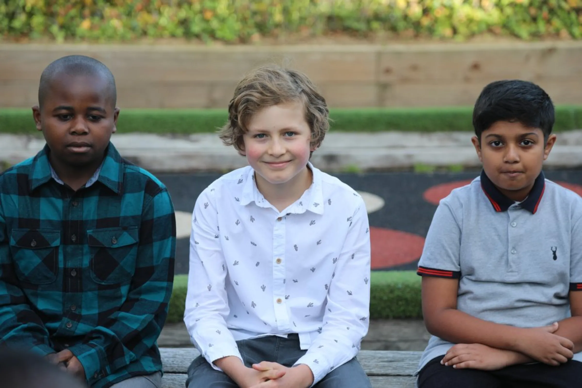 Alusine Fane, 11 (left), sits with other students from Prior Weston Primary School in central London, England, on September 23, 2021. “I worry about future generations even though it’s not something I should have to worry about,” he says