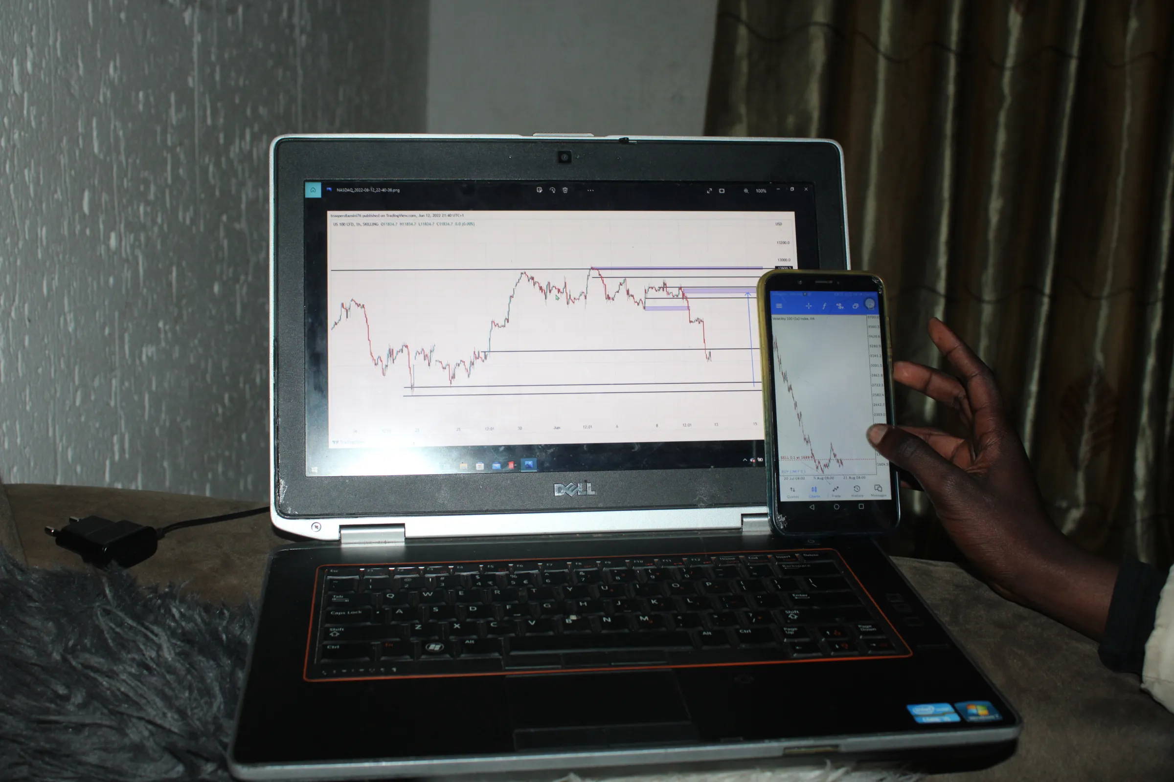 A young man shows his cryptocurrency trades on his mobile phone in Tsakane Township, South Africa.  August 21, 2022. Thomson Reuters Foundation/Kimberly Mutandiro