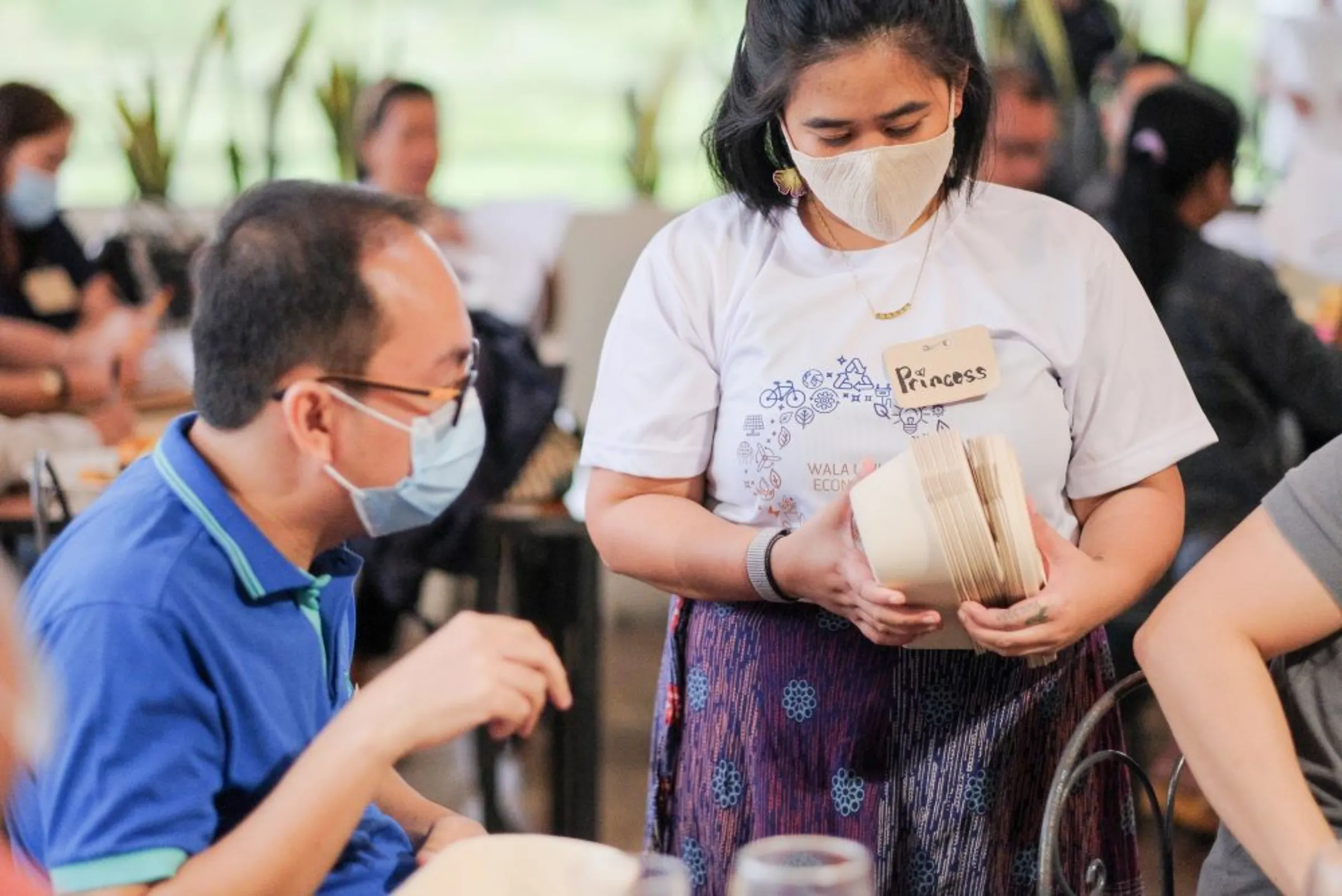 Bala-an inspects an alternative packaging model during the Wala Usik Economy Stakeholder Consultation in Talisay City in February 2021