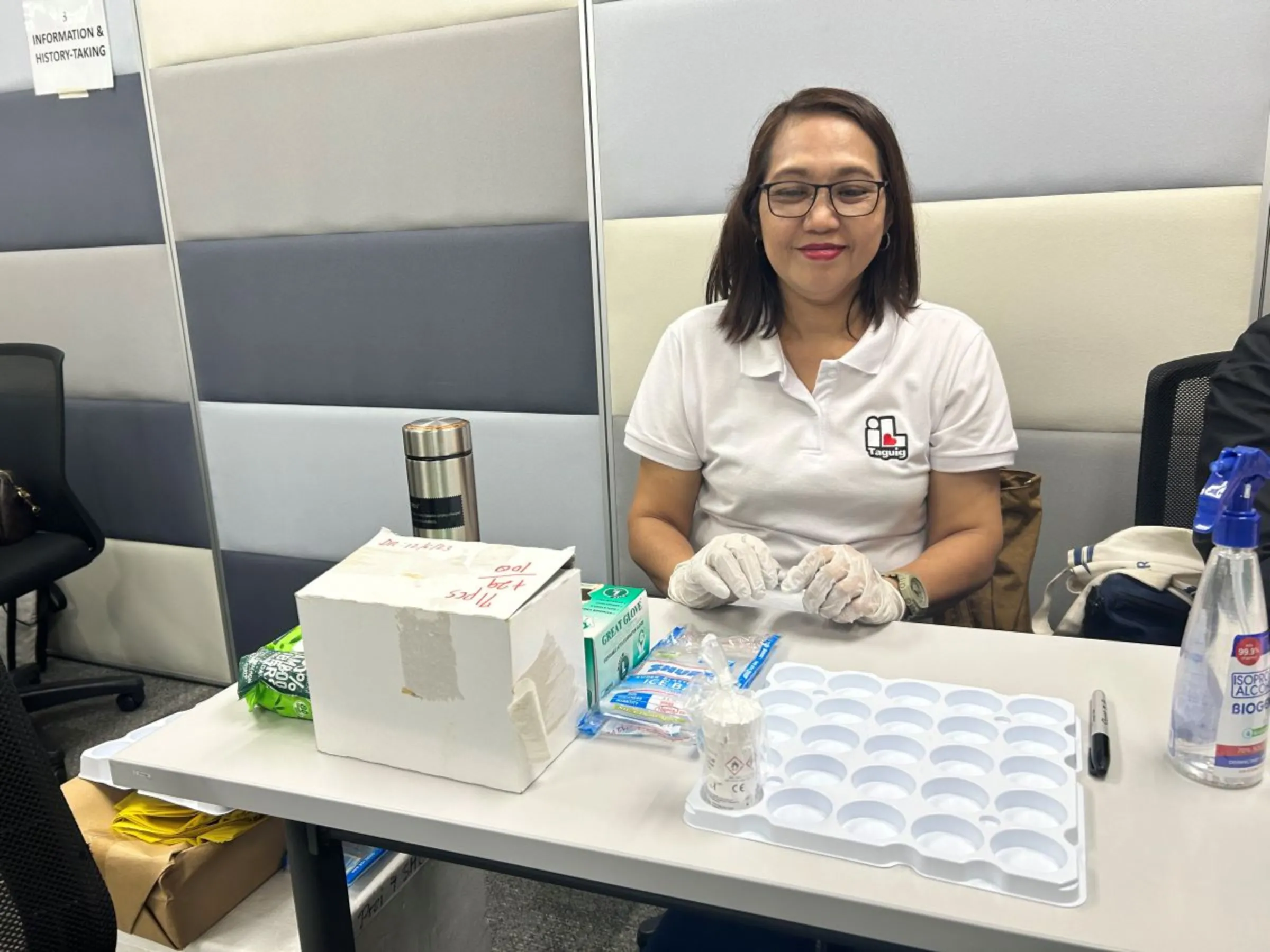 Health officers from Taguig City government assist Jhpiego and Home Credit during an HPV screening on Jan. 26. Mariejo Ramos/Thomson Reuters Foundation