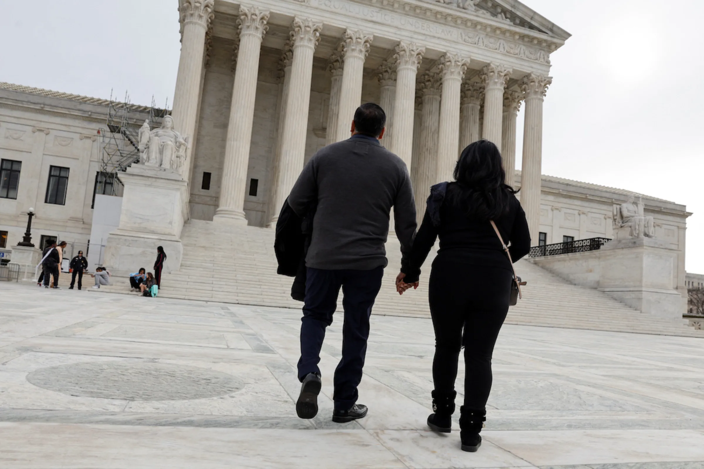 Beatrice Gonzalez and Jose Hernandez, the mother and stepfather of Nohemi Gonzalez, who was fatally shot and killed in a 2015 rampage by Islamist militants in Paris, walk to pose for a picture with a member of their legal team outside the U.S. Supreme Court in Washington, U.S., February 16, 2023, days before justices are scheduled hear arguments in Gonzalez v. Google, challenging federal protections for internet and social media companies freeing them of responsibility for content posted by users in a case involving social media giant Google and its subsidiary YouTube, whom they argue bear some responsibility for their daughter’s death. REUTERS/Jonathan Ernst