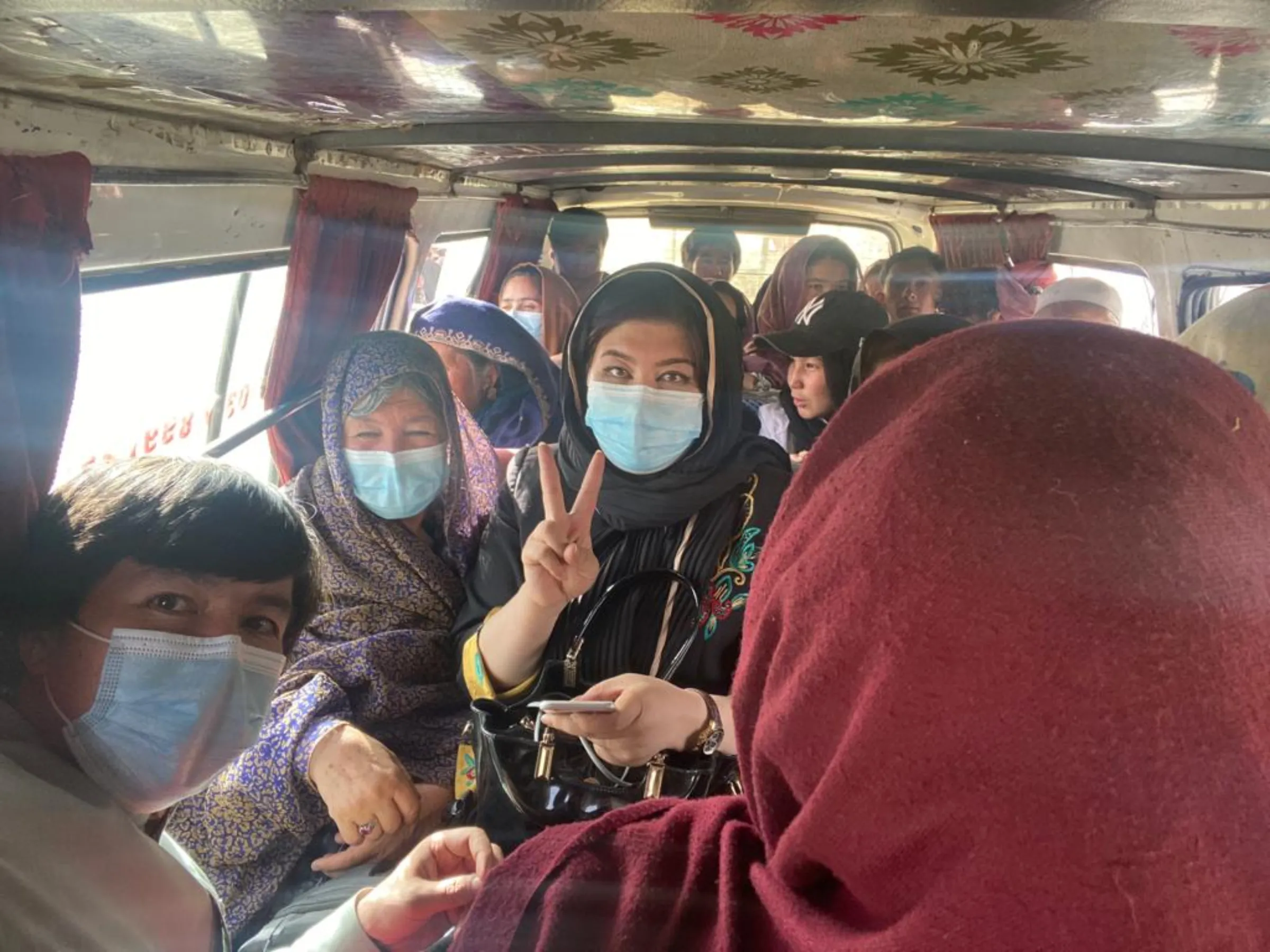 A family wearing COVID-19 masks are seen in a van