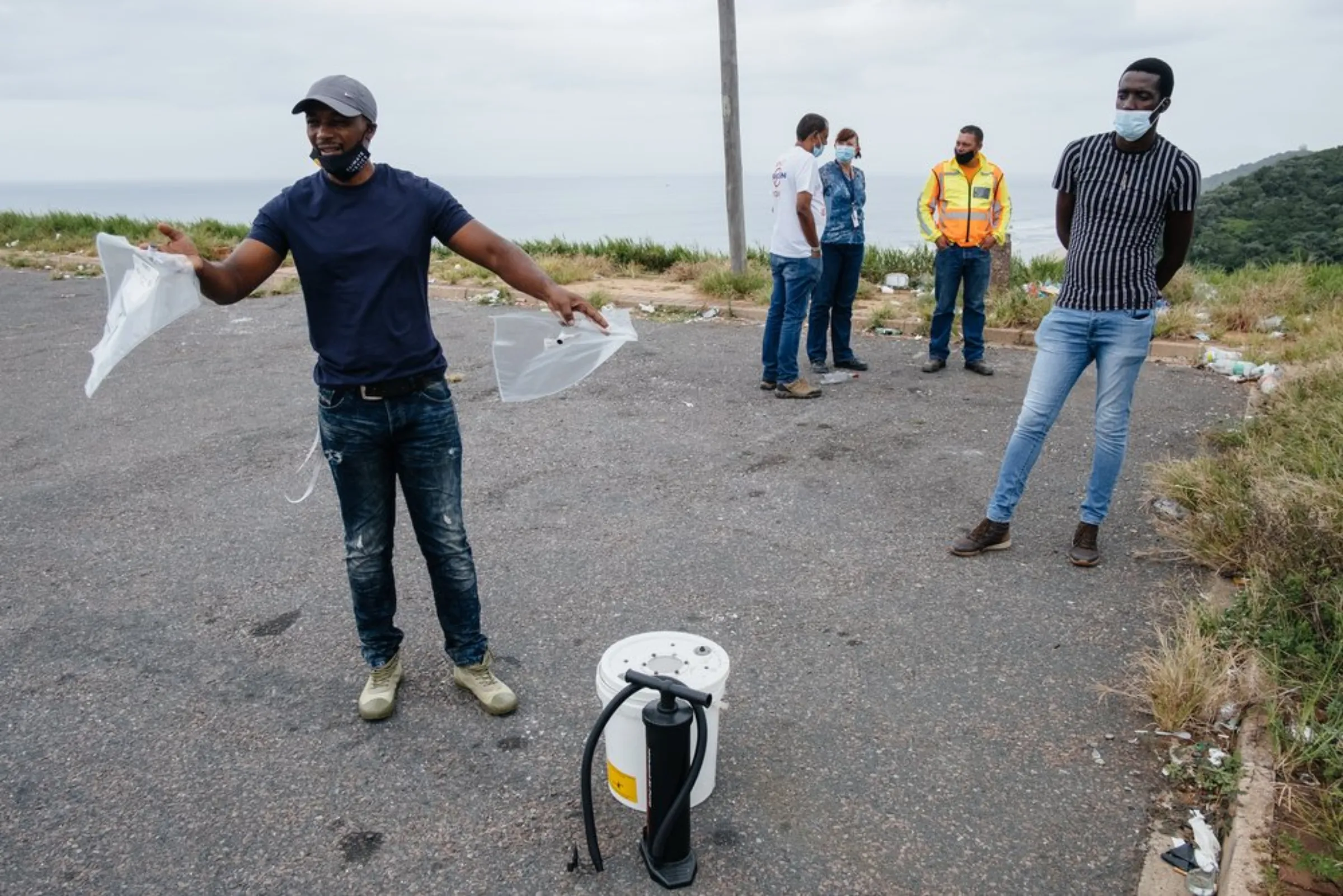 South Durban Community Environmental Alliance (SDCEA) members including Bongani Mthembu (left) prepare to measure air quality in south Durban, South Africa, April 1, 2021