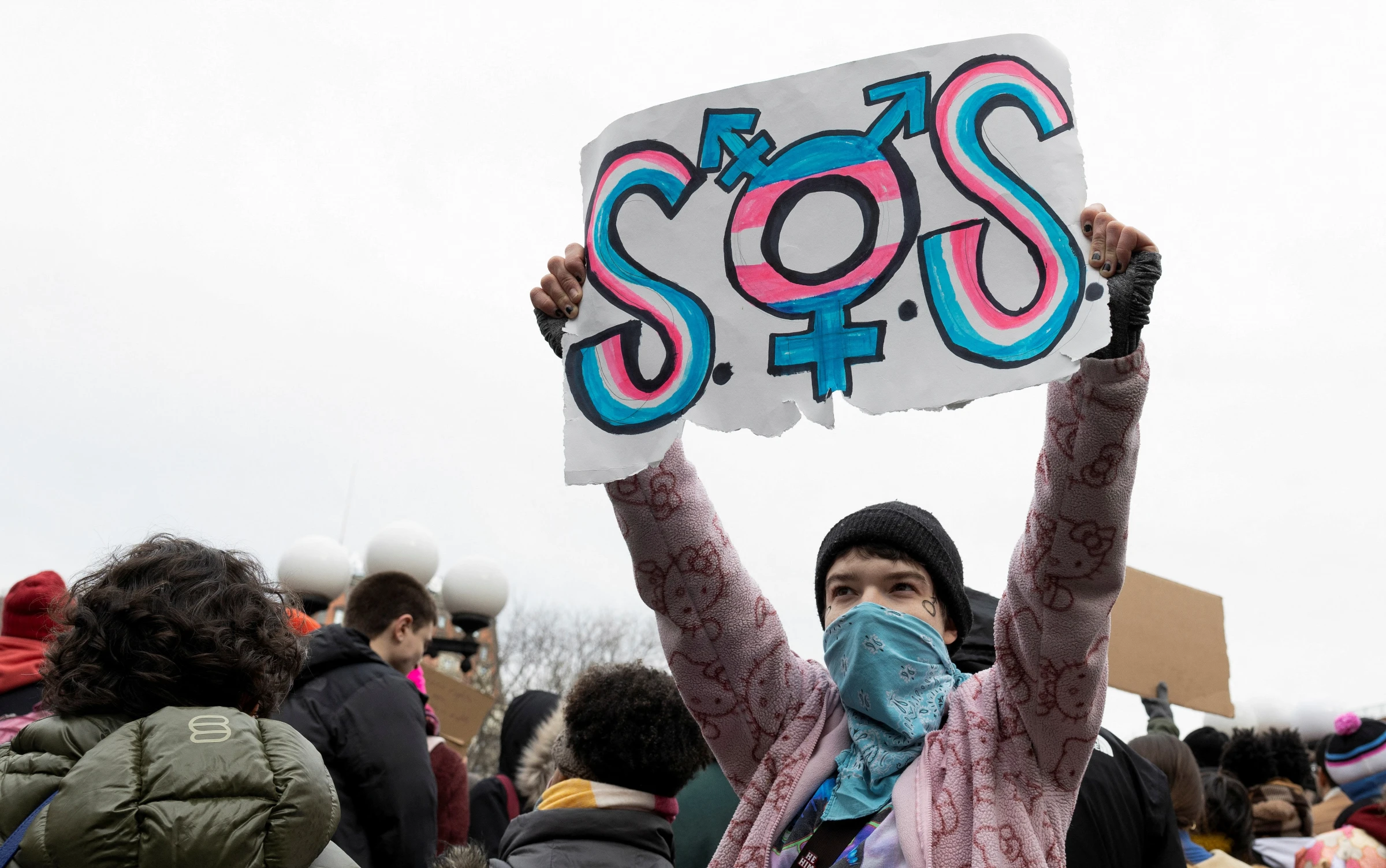 A demonstrator holds a sign at a Rise Up for Trans Youth! event in New York City, U.S., February 8, 2025. REUTERS/Christian Monterrosa