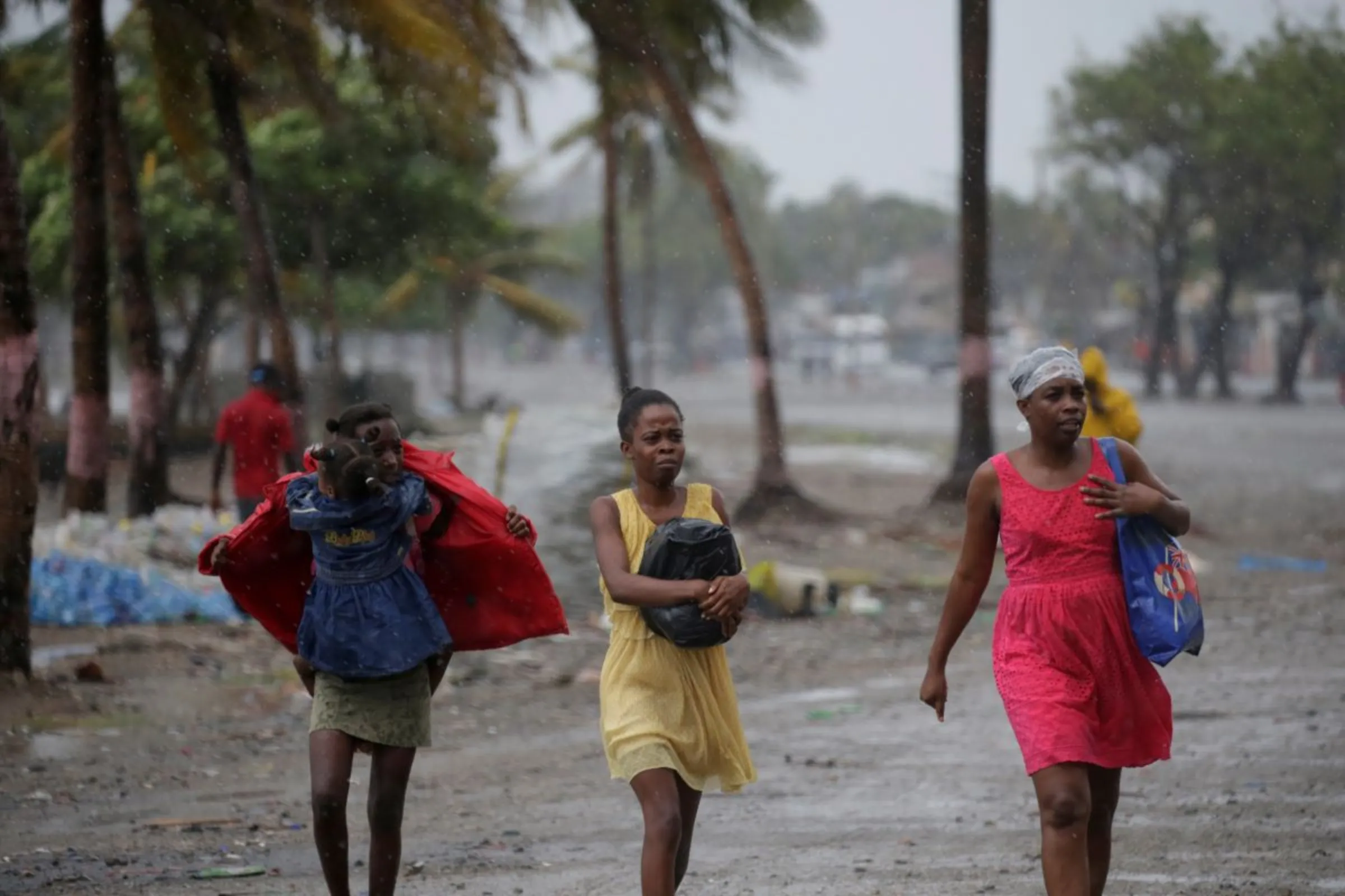 Women walk in the rain brought by Hurricane Irma in Cap-Haitien, Haiti, September 7, 2017. REUTERS/Andres Martinez Casares