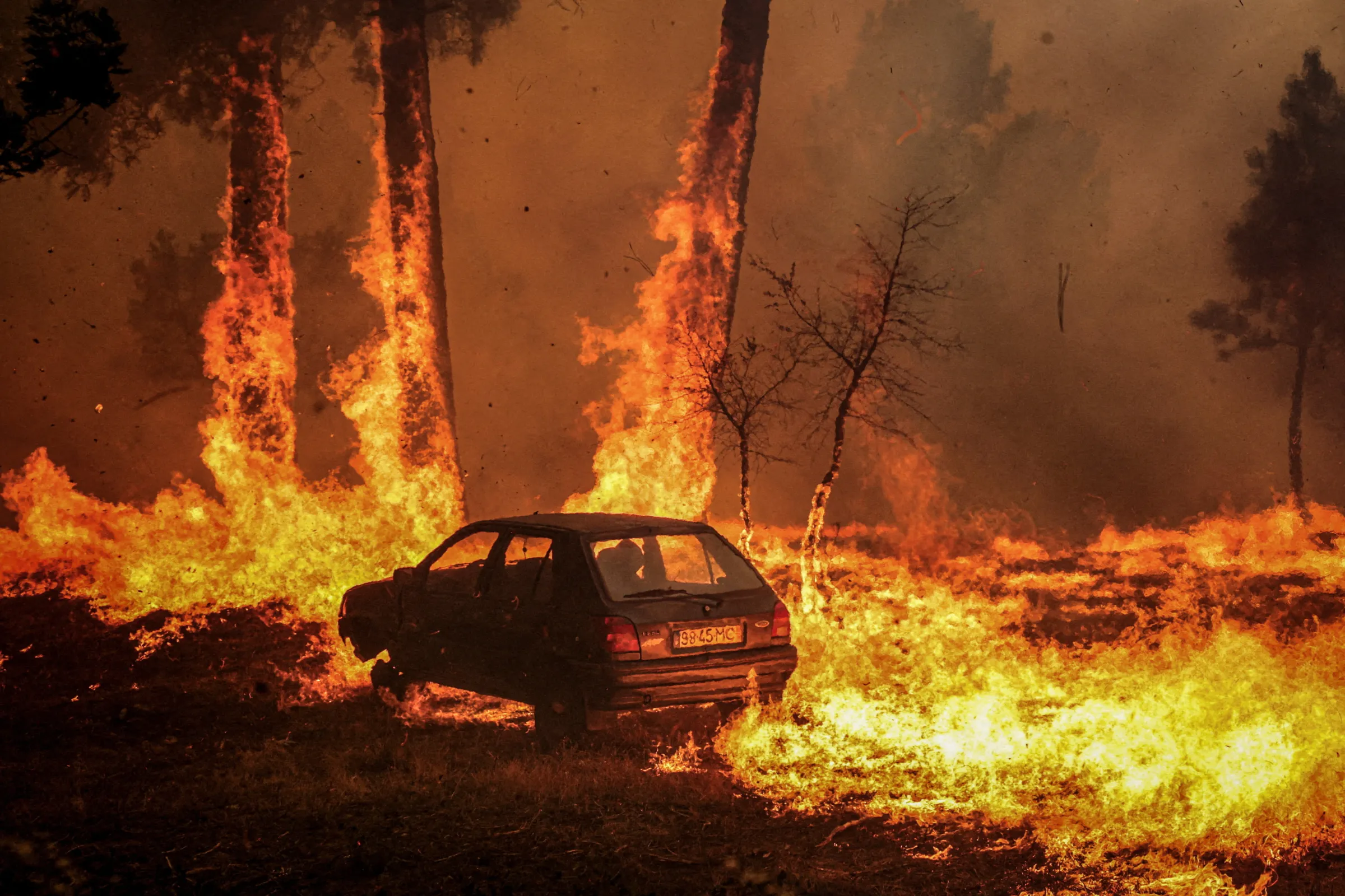 A car burns during the wildfire, in Meda, Portugal, August 15, 2025. REUTERS/Pedro Nunes
