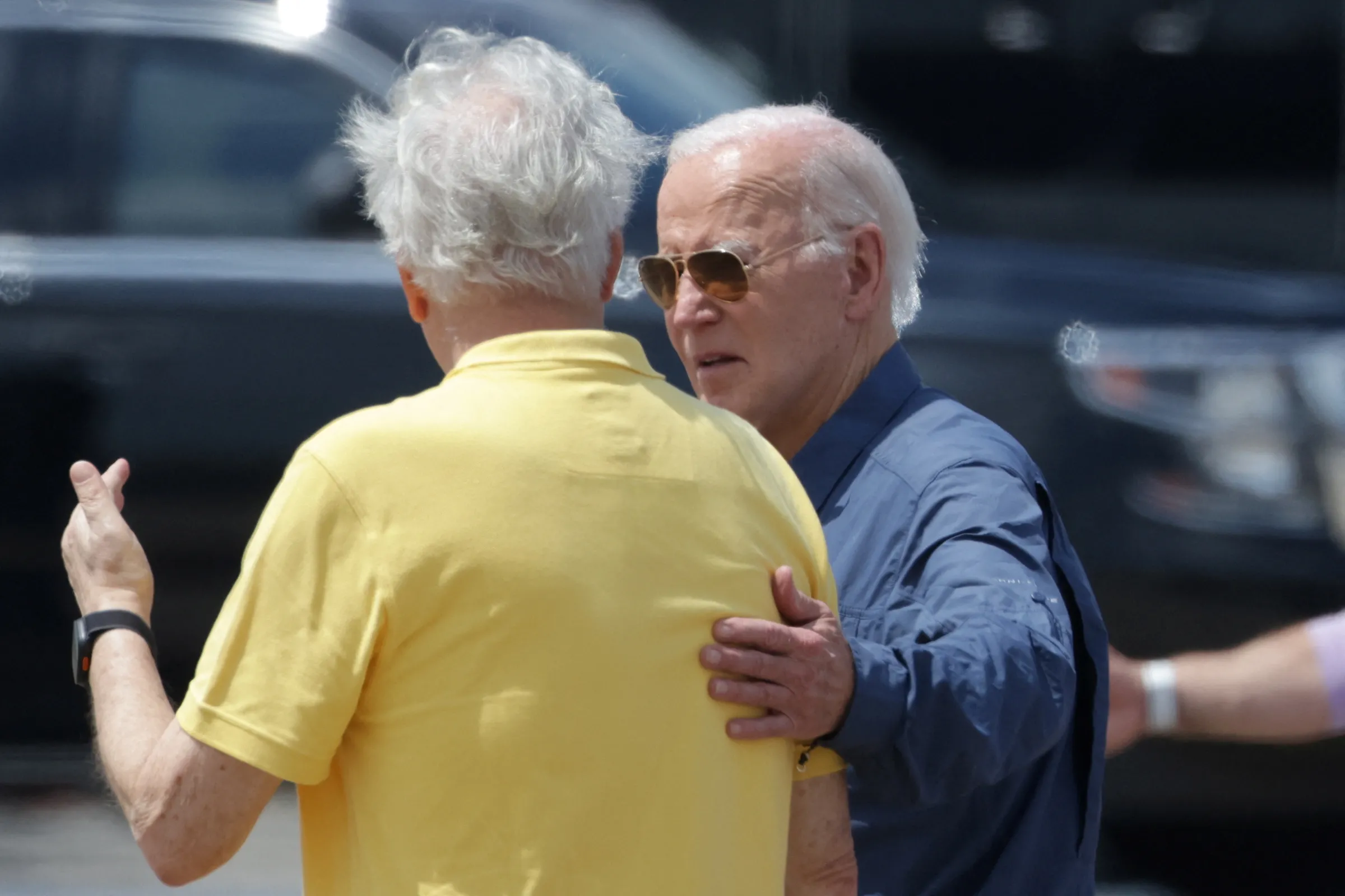 U.S. President Joe Biden talks to Brazilian scientist Carlos Nobre at the Eduardo Gomes International Airport in Manaus, Brazil, November 17, 2024. REUTERS/Bruno Kelly