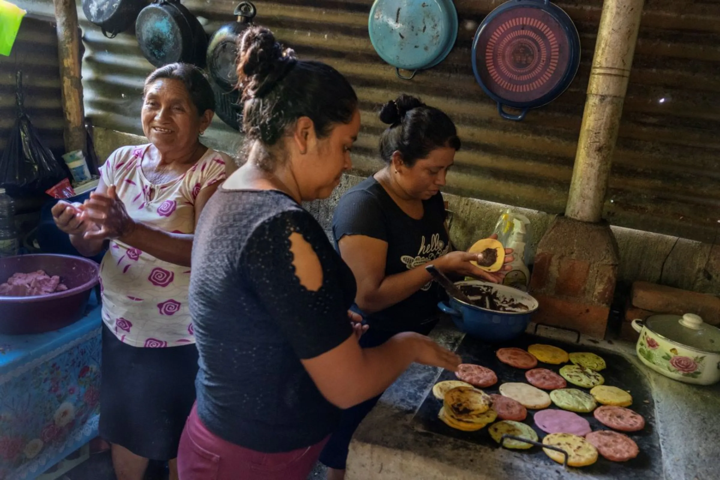 Women bean farmers prepare tortillas stuffed with Chorti beans, a staple crop in Guatemala in a kitchen in the province of Chiquimula, Guatemala, September 6, 2023. Thomson Reuters Foundation/Fabio Cuttica