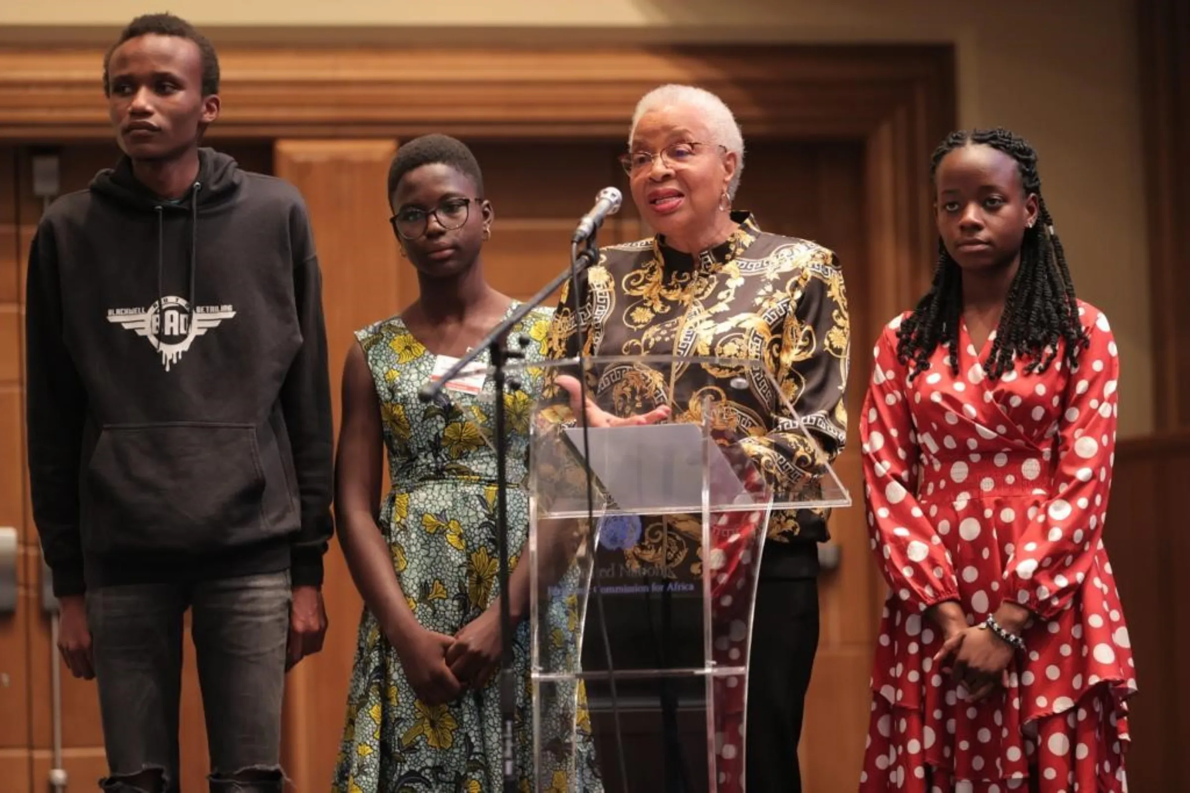 Young climate activists Eric Njuguna, Guileda Ashanti and Leah Namugerwa (L-R background) listen as Graca Machel (foreground) speaks at the Ninth International Policy Conference on the African Child (IPC) organised by the African Child Policy Forum (ACPF) in Addis Ababa, Ethiopia September 2022