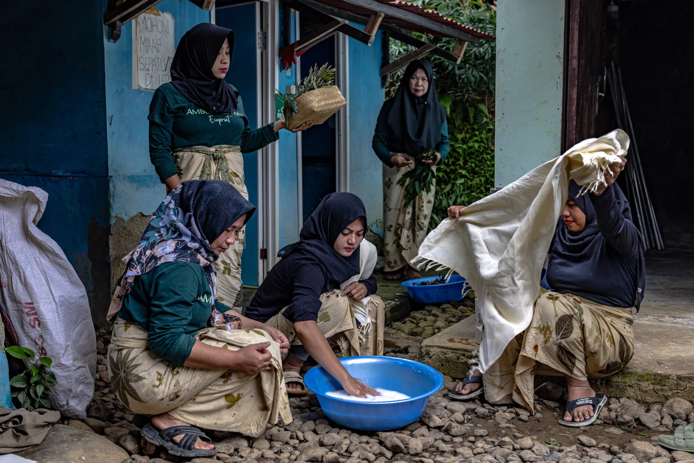 Members of the Ambu Halimun community prepare fabric along with leaves and flowers gathered from their surroundings for the ecoprinting process in Citalahab Central, West Java, Indonesia, on July 16, 2025. Thomson Reuters Foundation/Yudha Baskoro