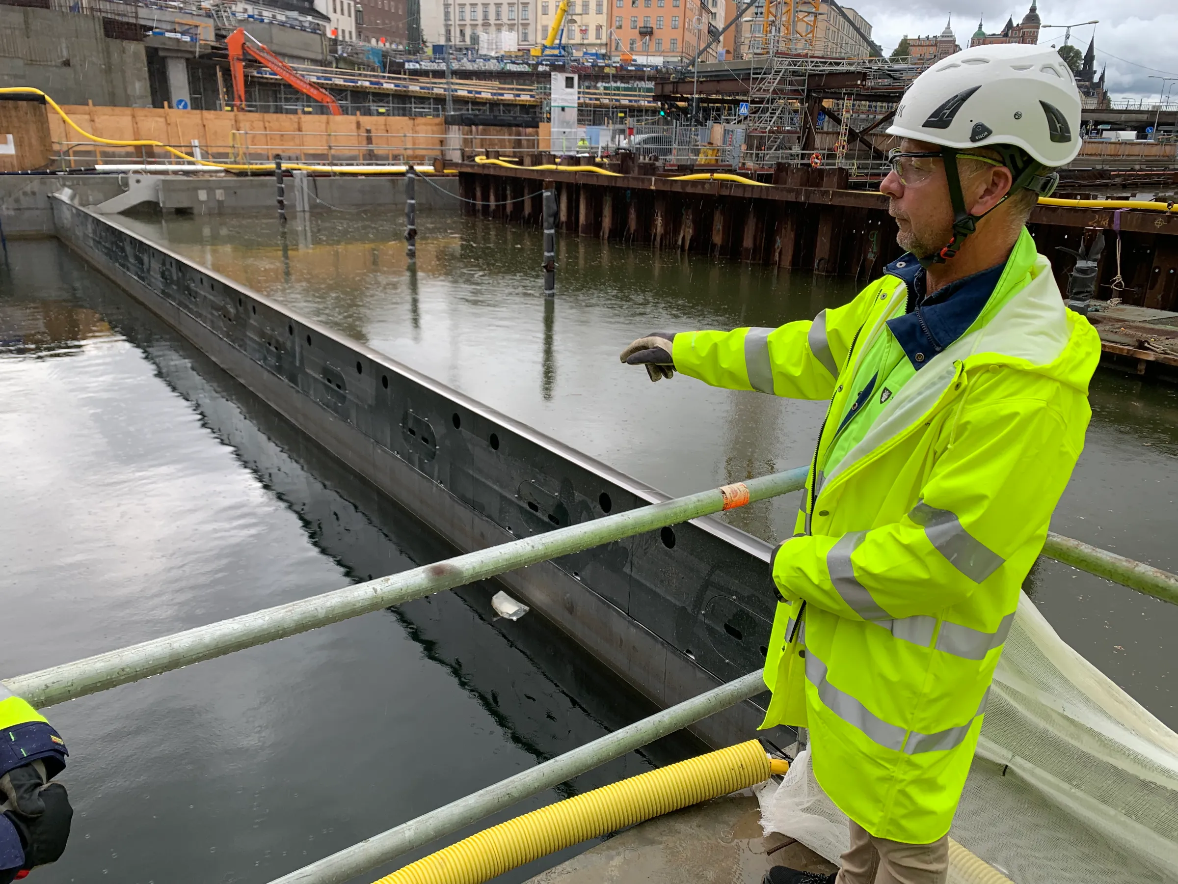 Magnus Tengblad, coordinating construction manager water for the Slussen project in Stockholm, Sweden,  points to a new sluice gate separating the fresh water of Lake Malaren (right), which is 70 cm higher than the Baltic Sea (left) as part of a renovation, September 16, 2022