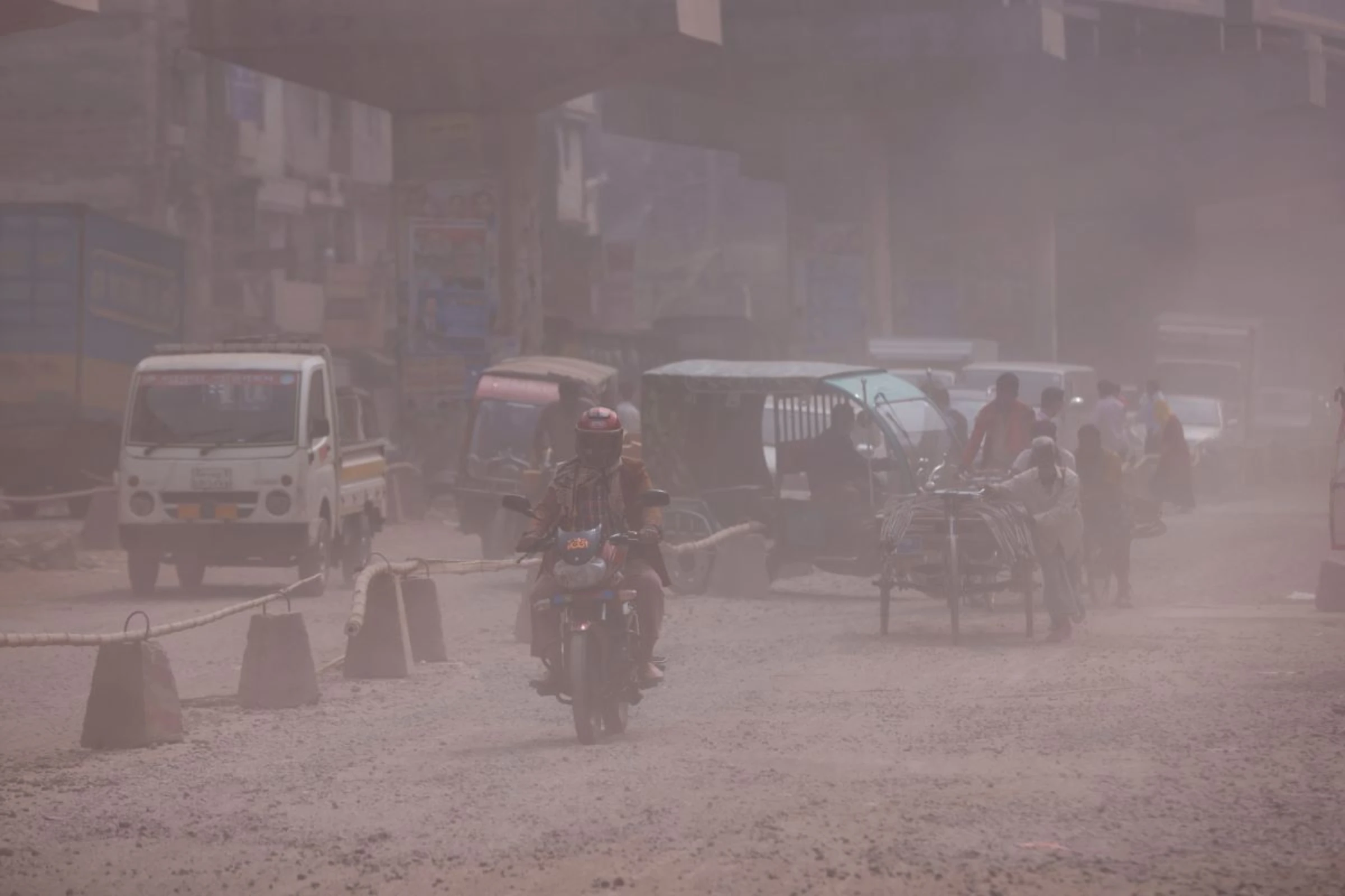 Vehicles are moving on a dusty road as air pollution worsens during winters in Tongi area of Gazipur, Bangladesh, February 3, 2022. REUTERS/Mohammad Ponir Hossain