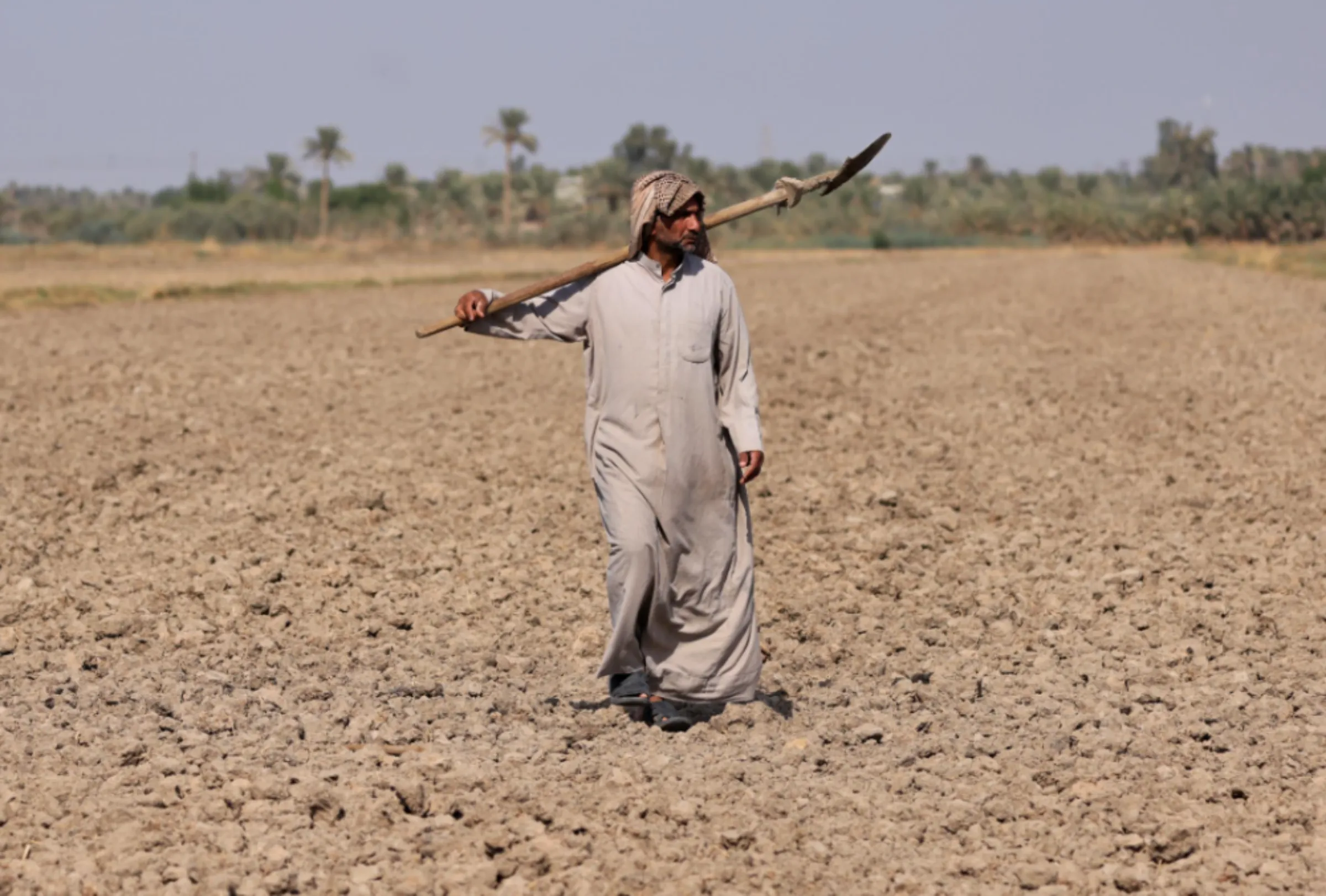 Abed Hameed al-Brahim walks in his farm in al-Mishkhab district in Najaf, Iraq, October 12, 2022