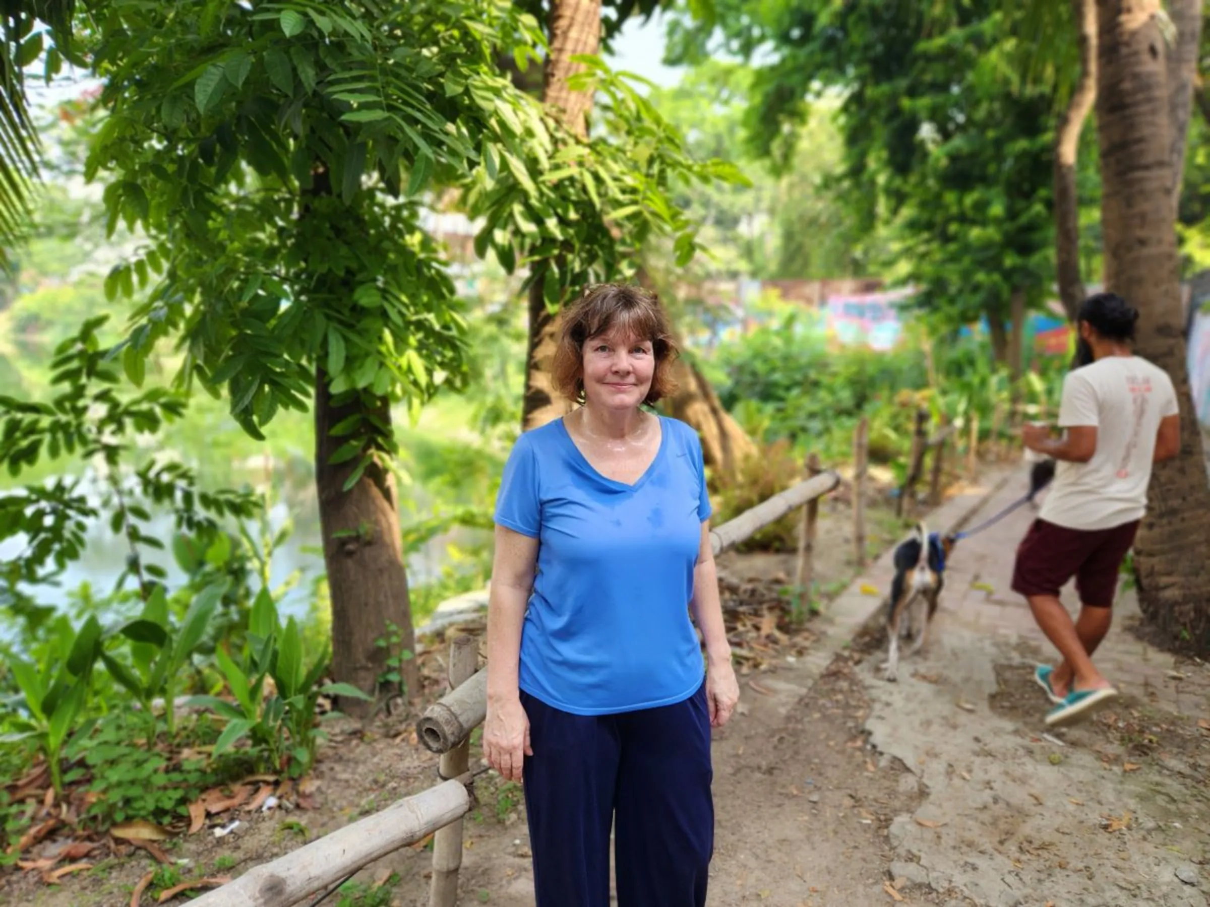 Treena Bishop , a U.S. citizen living in Dhaka, poses beside the Gulshan Lakeside where she works as a volunteer as part of the '55 Kodomtola: Greening the Gulshan Lakeside' initiative, Dhaka, Bangladesh, April 26, 2024. Thomson Reuters Foundation/Mosabber Hossain