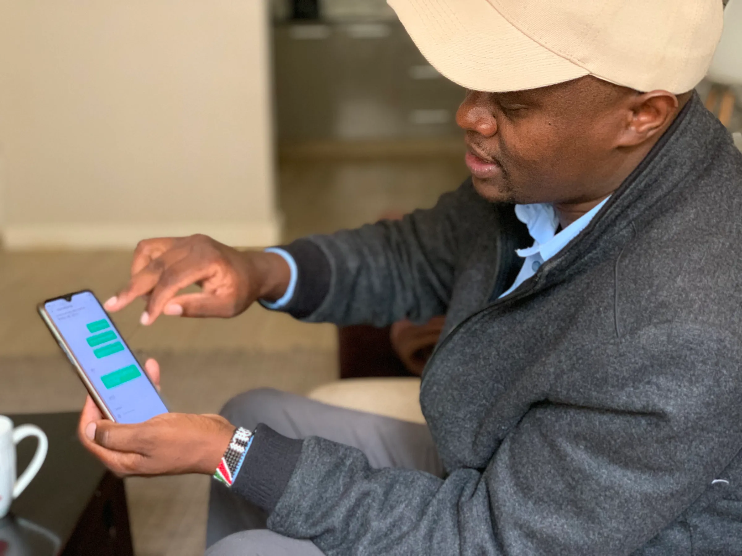 A man shows text messages sent to him by digital lender Ipesa in Nairobi, Kenya on Nov. 29, 2021. Thomson Reuters Foundation/Nita Bhalla