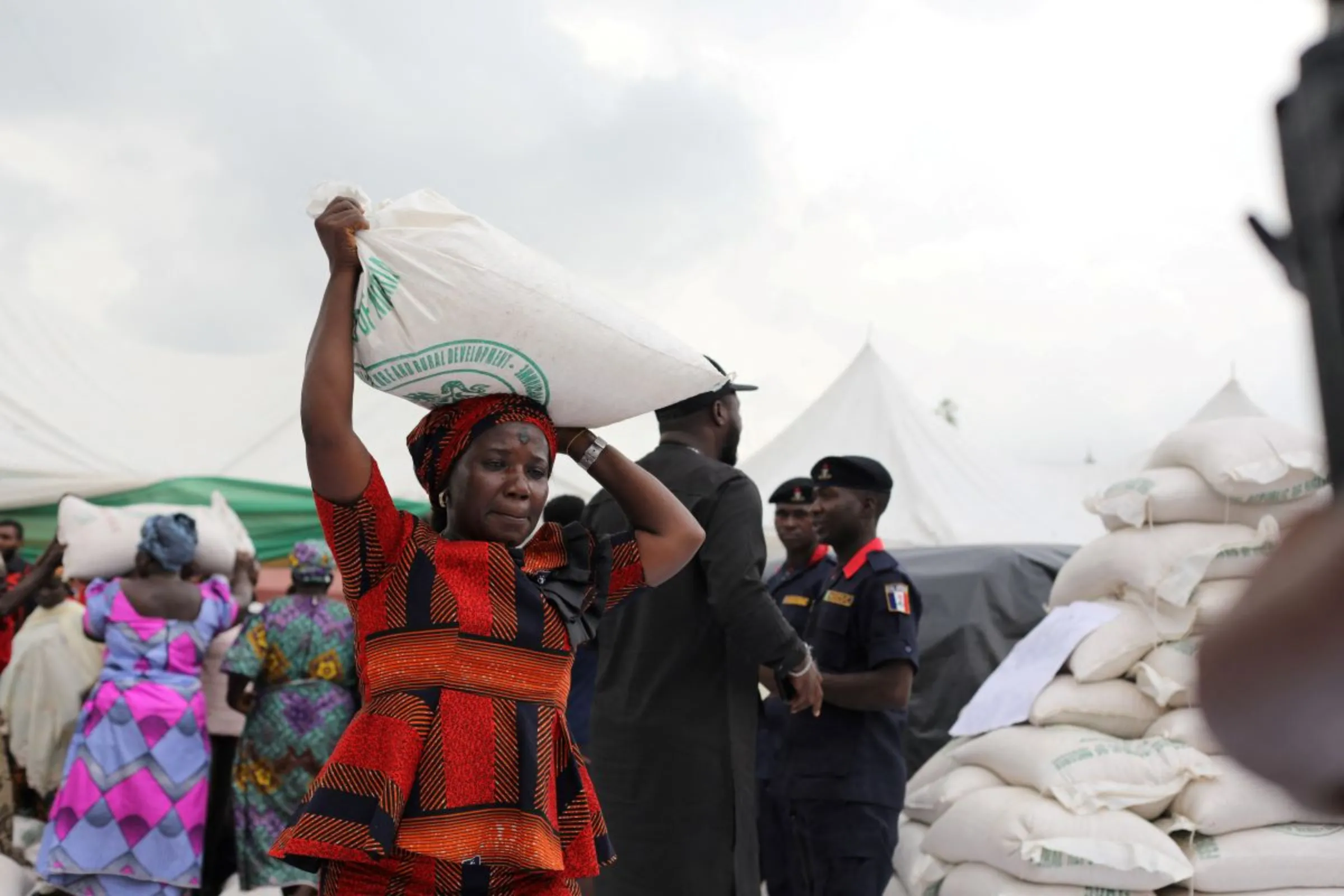 A woman receives a bag of food from the government during the distribution of food items by the government to cushion the high cost of living in Abuja, Nigeria, September 20, 2022. REUTERS/Afolabi Sotunde
