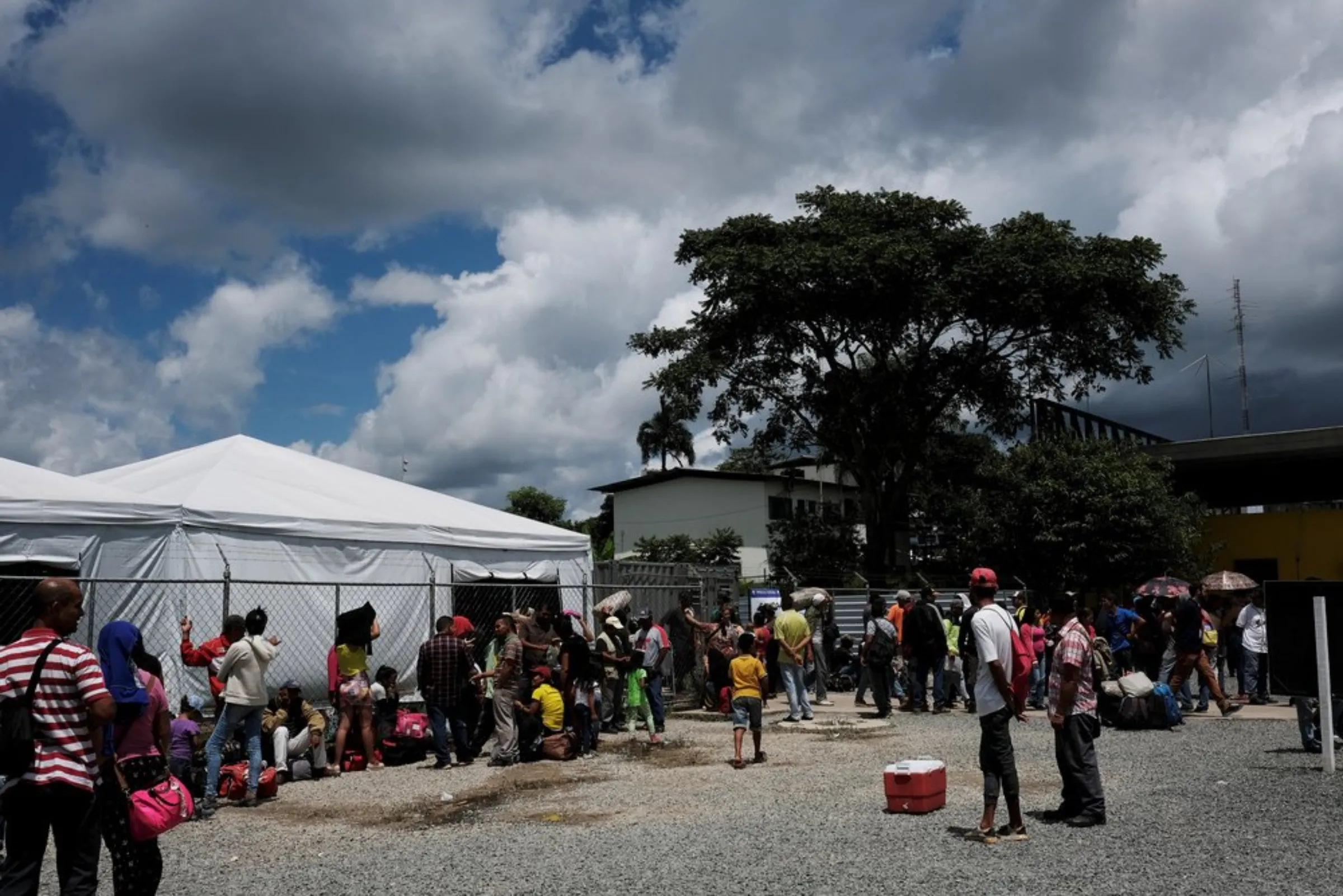 Venezuelans queue in line to show their passports or identity cards at the Pacaraima border control, Roraima state, Brazil August 8, 2018