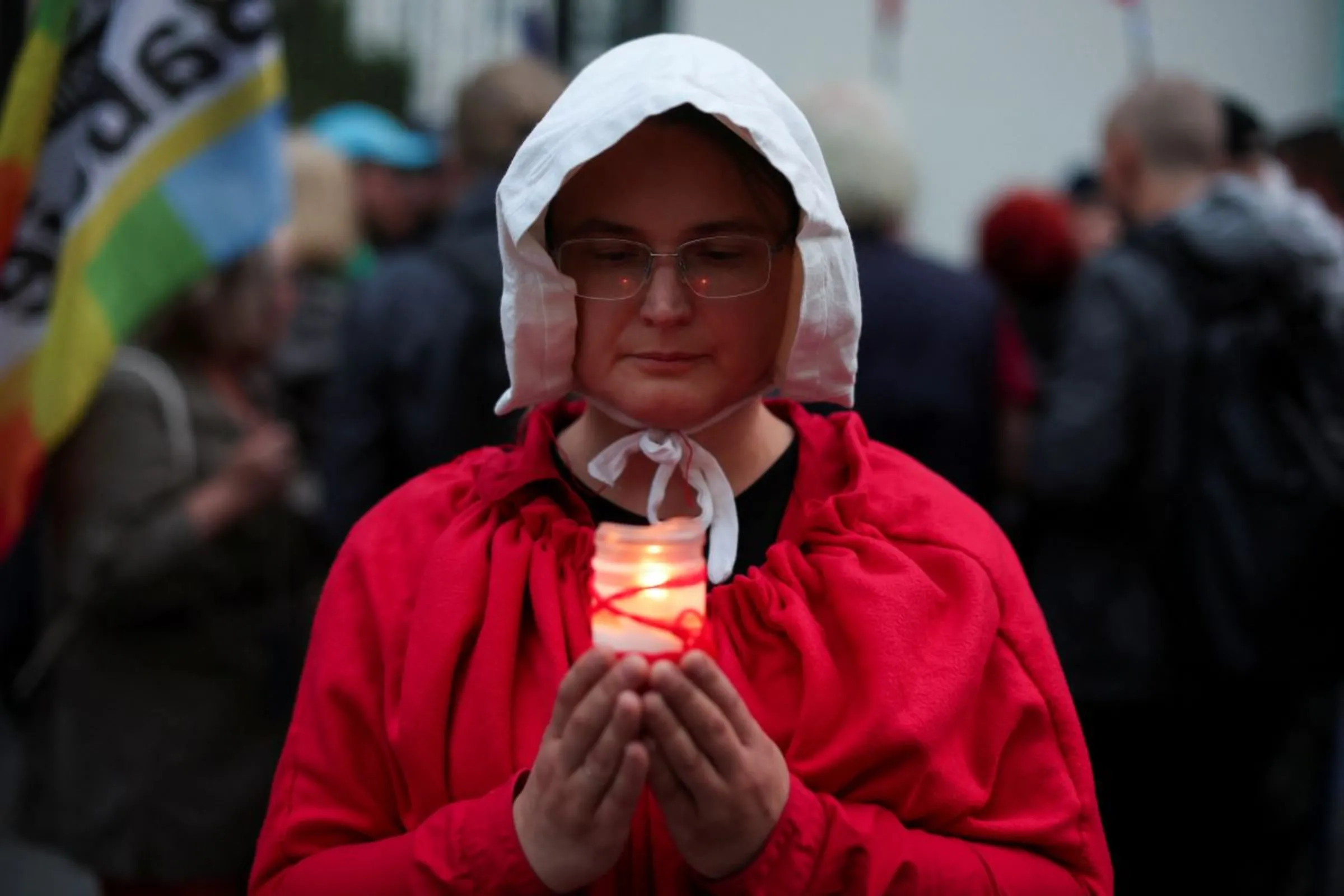 A person wearing a red cape takes part in a protest, after a pregnant woman died in hospital in an incident campaigners say is the fault of Poland's laws on abortion, which are some of the most restrictive in Europe, in Warsaw, Poland June 14, 2023. REUTERS/Kacper Pempel