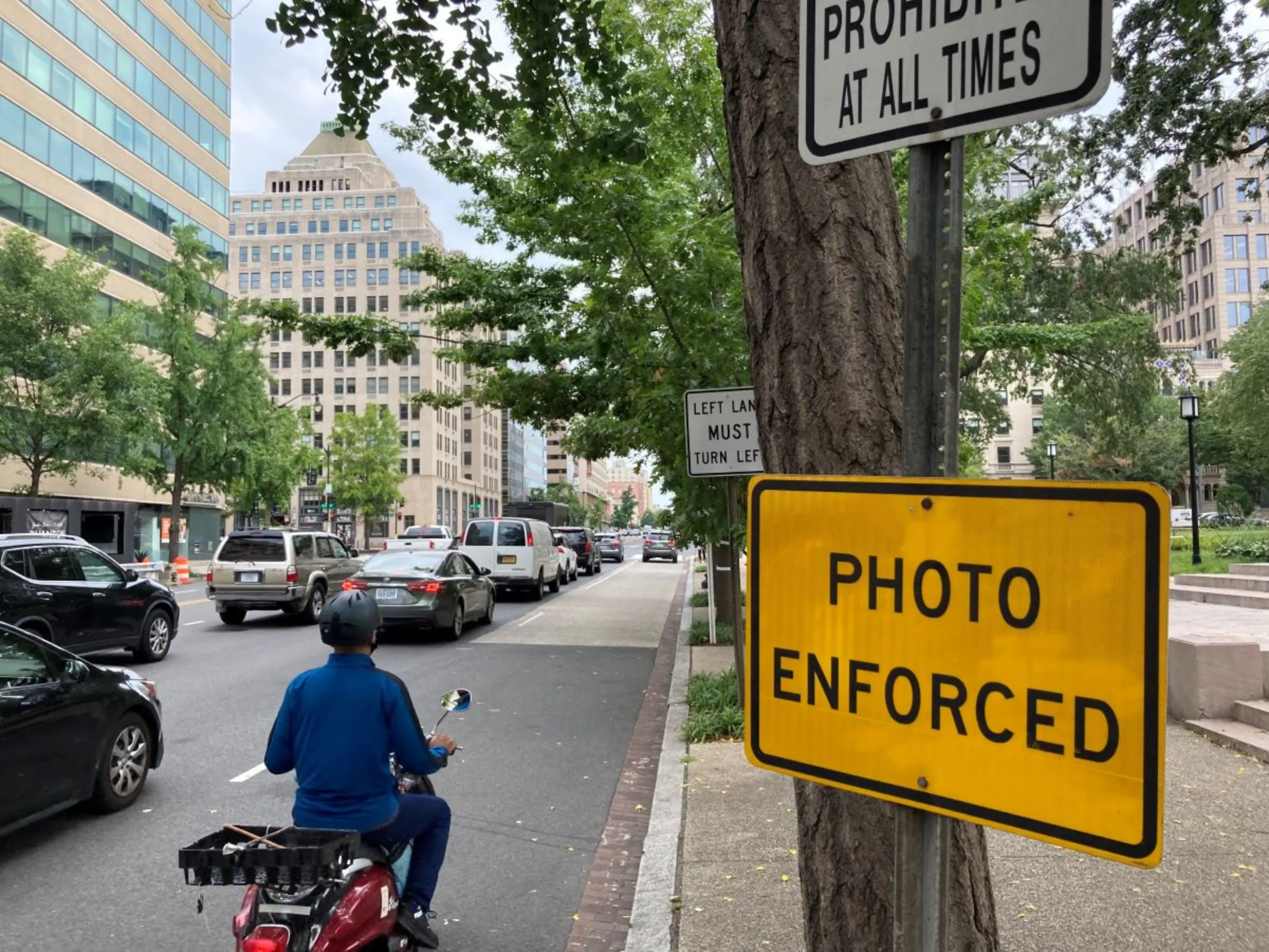 A sign alerts drivers to an upcoming traffic camera at an intersection in Washington in August 2023