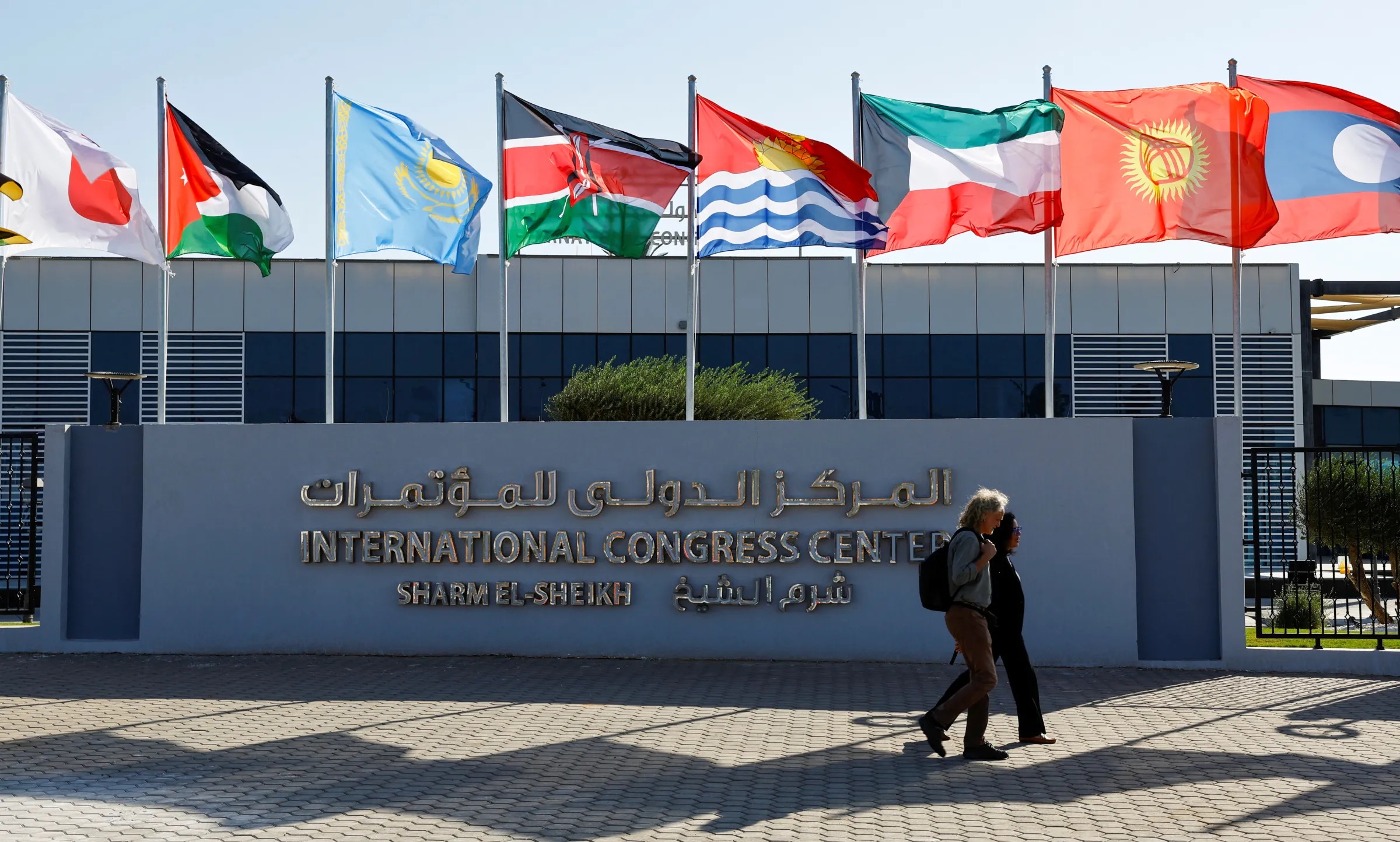 Participants walk outside of the Sharm El Sheikh International Convention Centre before the COP27 climate summit opening in Egypt's Red Sea resort of Sharm el-Sheikh, Egypt