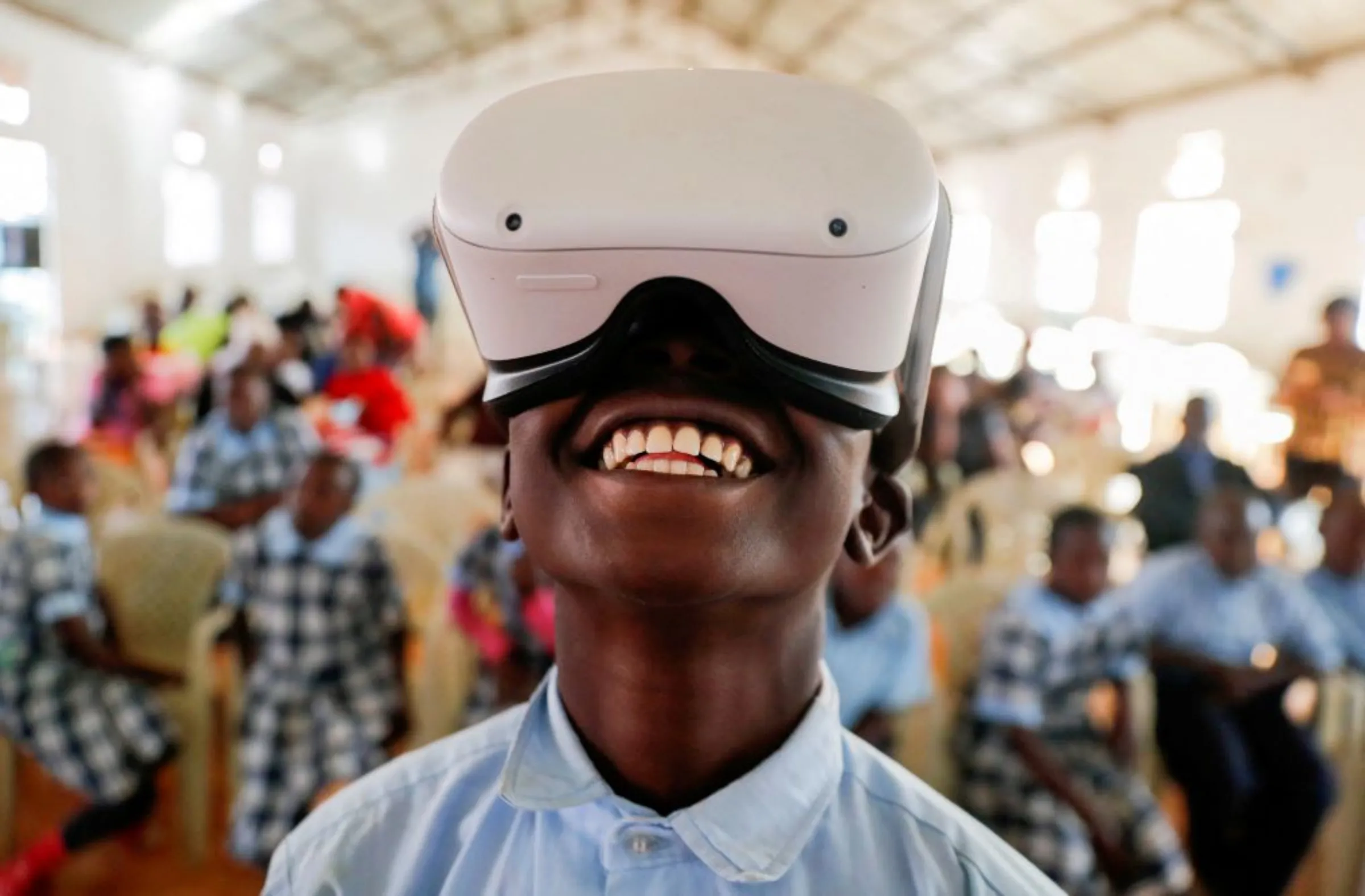 A boy uses an Oculus virtual reality (VR) headset, to virtually visit Buckingham Palace during the celebration of Britain's Queen Elizabeth's Platinum Jubilee, in Nyeri, Kenya June 2, 2022
