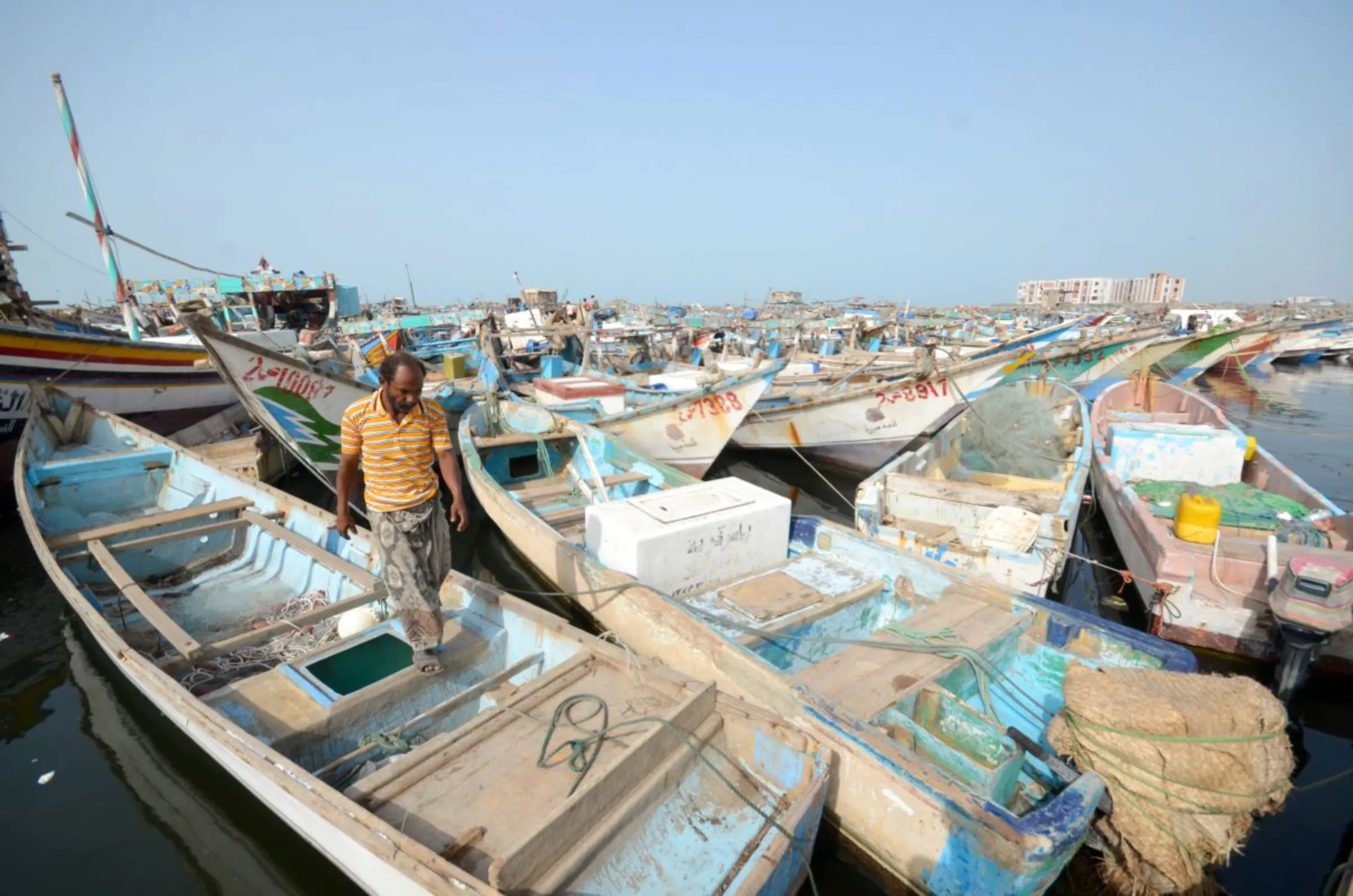 A fisherman walks on a boat docked at the Red Sea port of Hodeidah, Yemen February 5, 2017. REUTERS/Abduljabbar Zeyad