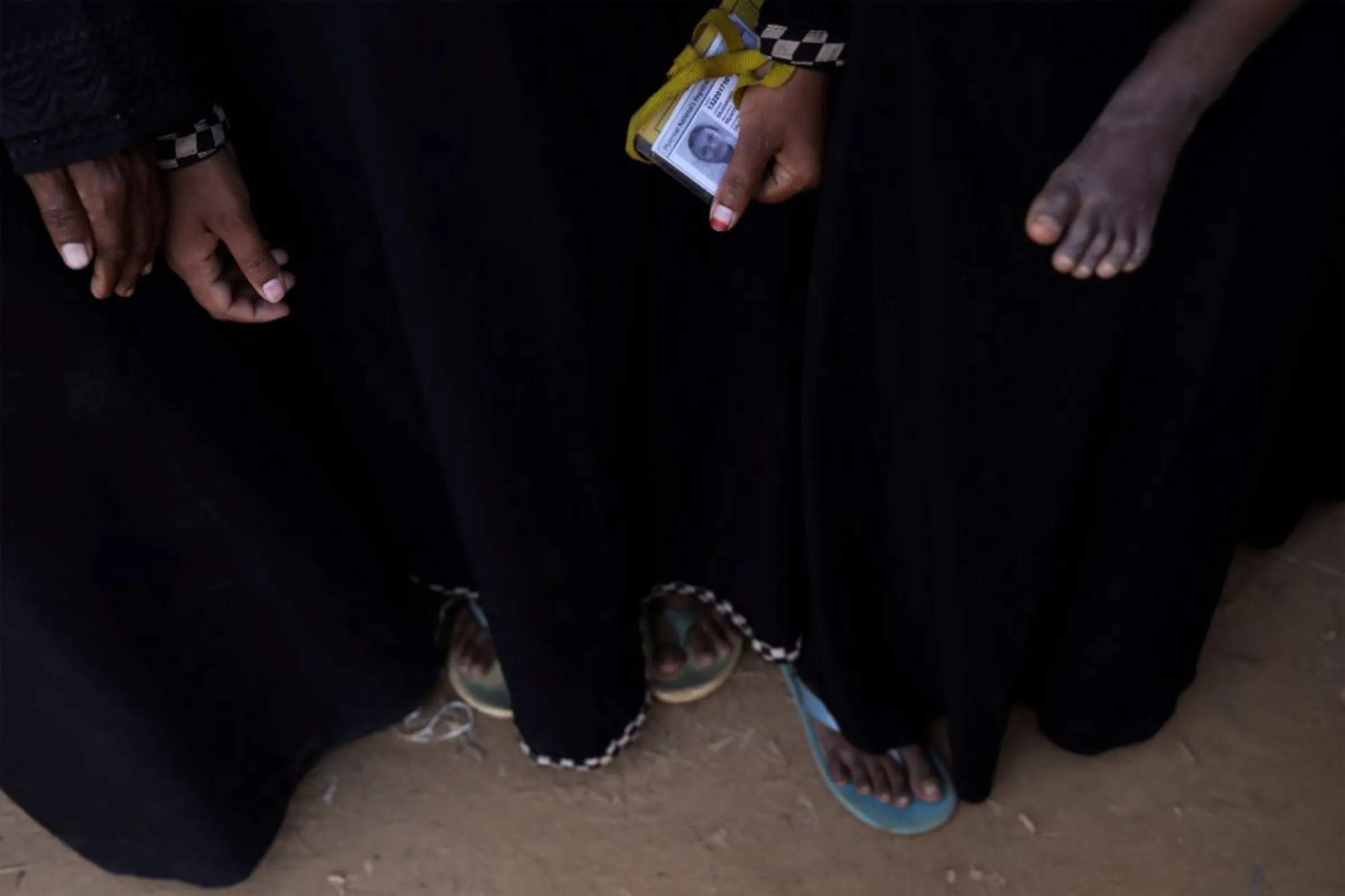 A Rohingya refugee woman holds her ID as she waits at a food distribution line at Kutupalong refugee camp, near Cox's Bazar, Bangladesh November 20, 2017