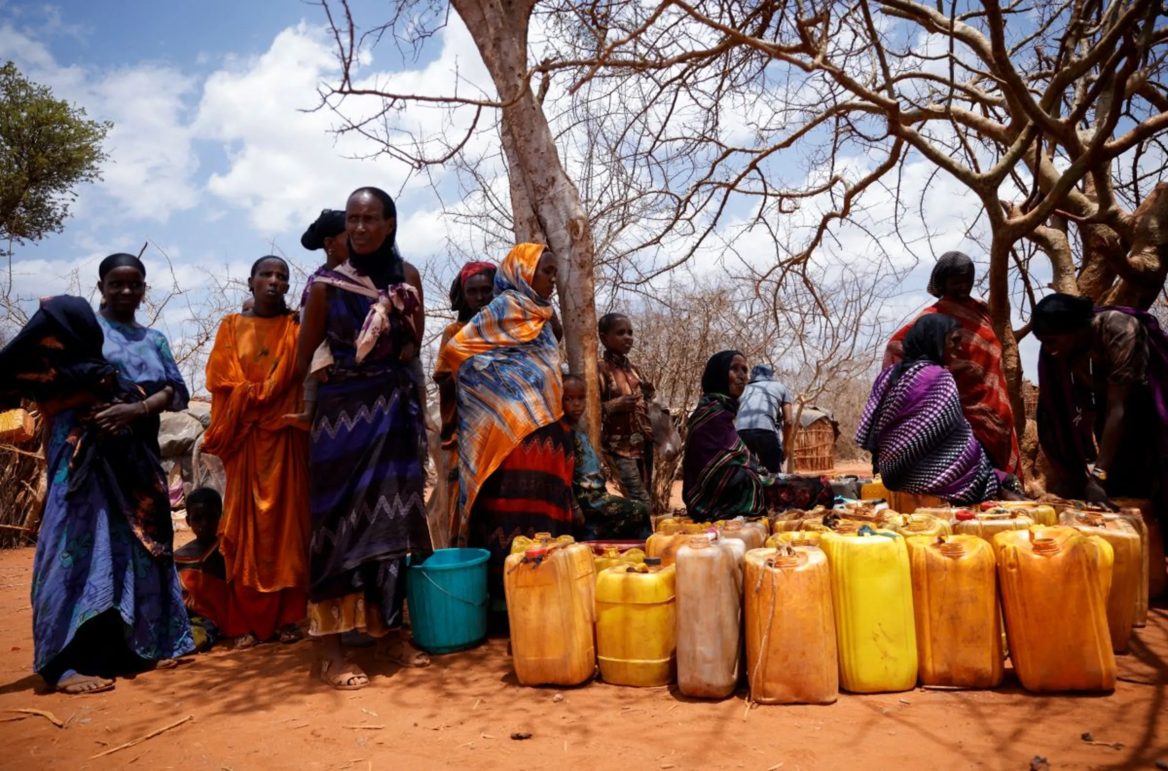 Women wait for a water truck in Kura Kalicha camp for the people internally displaced by drought near Das town, Oromiya region, Ethiopia March 7, 2023