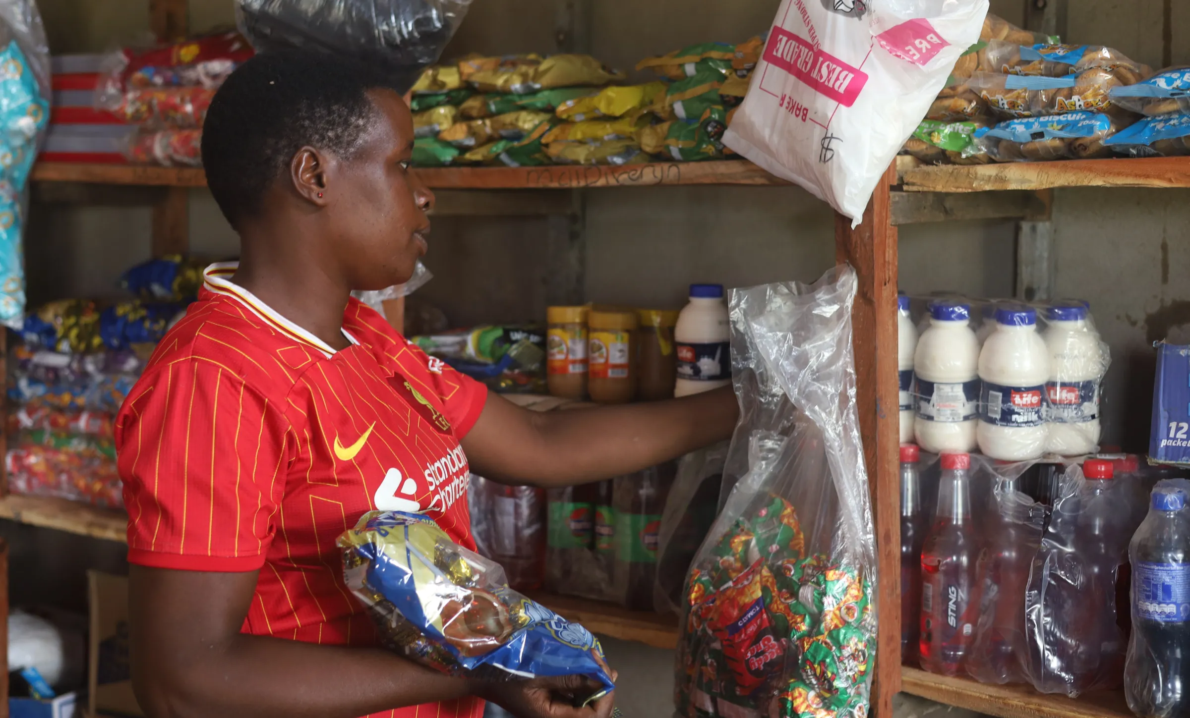 Joyce Chaipa stands inside her shop in Rushinga, Zimbabwe, Dec 7, 2025. Thomson Reuters Foundation/Farai Shawn Matiashe