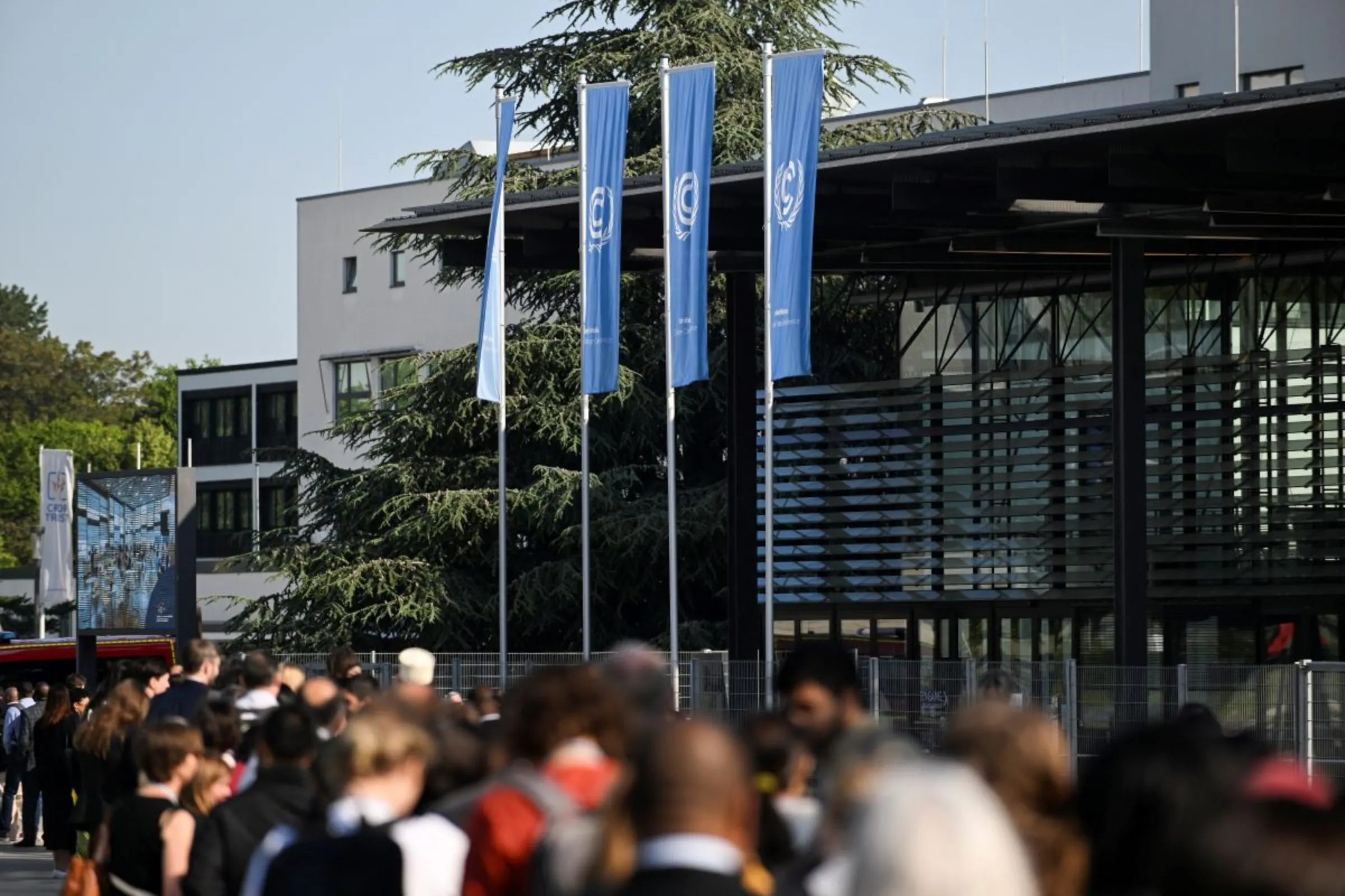 People wait in line to attend the Climate Change Conference in Bonn, Germany, June 6, 2023. REUTERS/Jana Rodenbusch