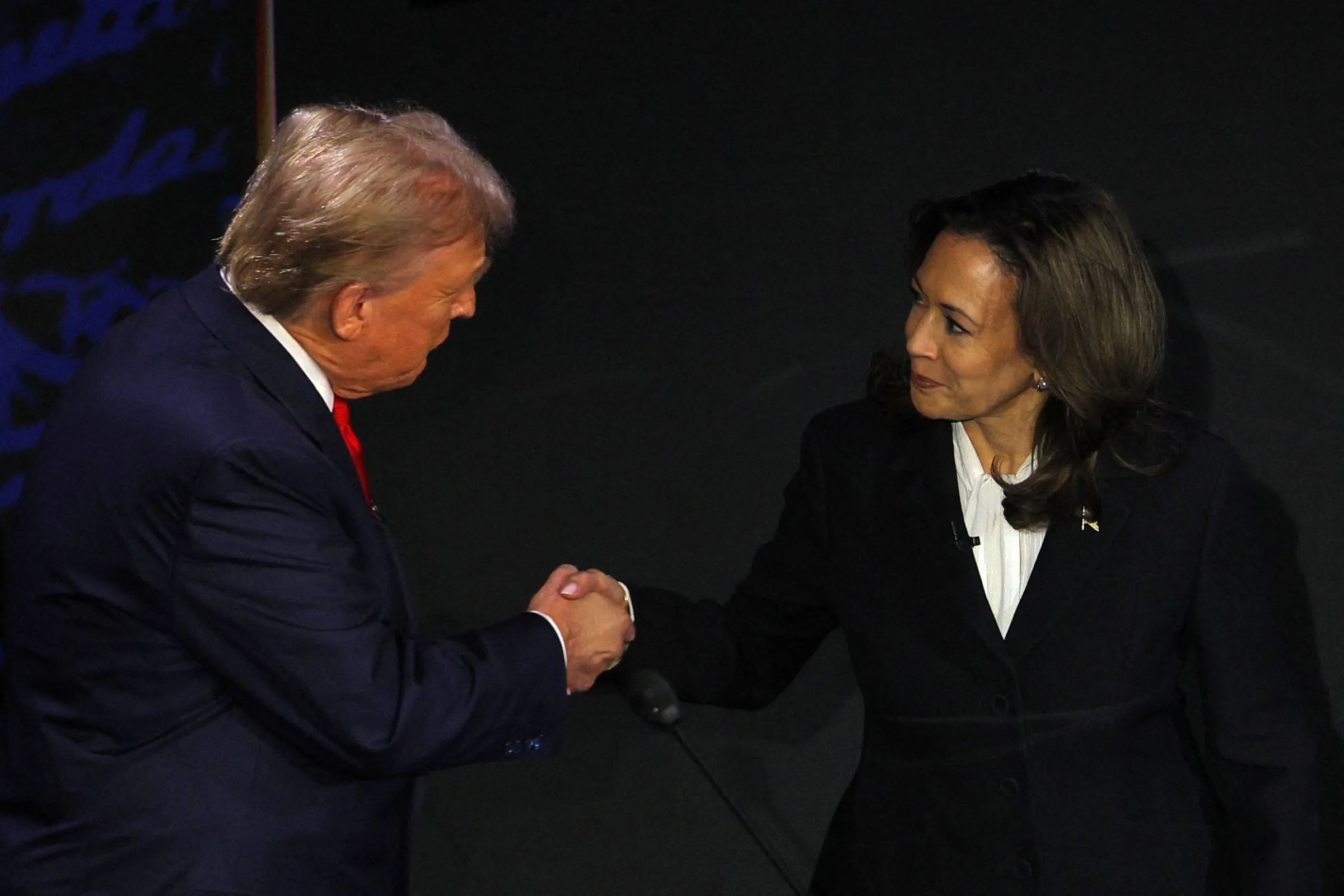 Republican presidential nominee, former U.S. President Donald Trump and Democratic presidential nominee, U.S. Vice President Kamala Harris shake hands as they arrive at their podiums to attend a presidential debate in Philadelphia, Pennsylvania, U.S., September 10, 2024. REUTERS/Brian Snyder