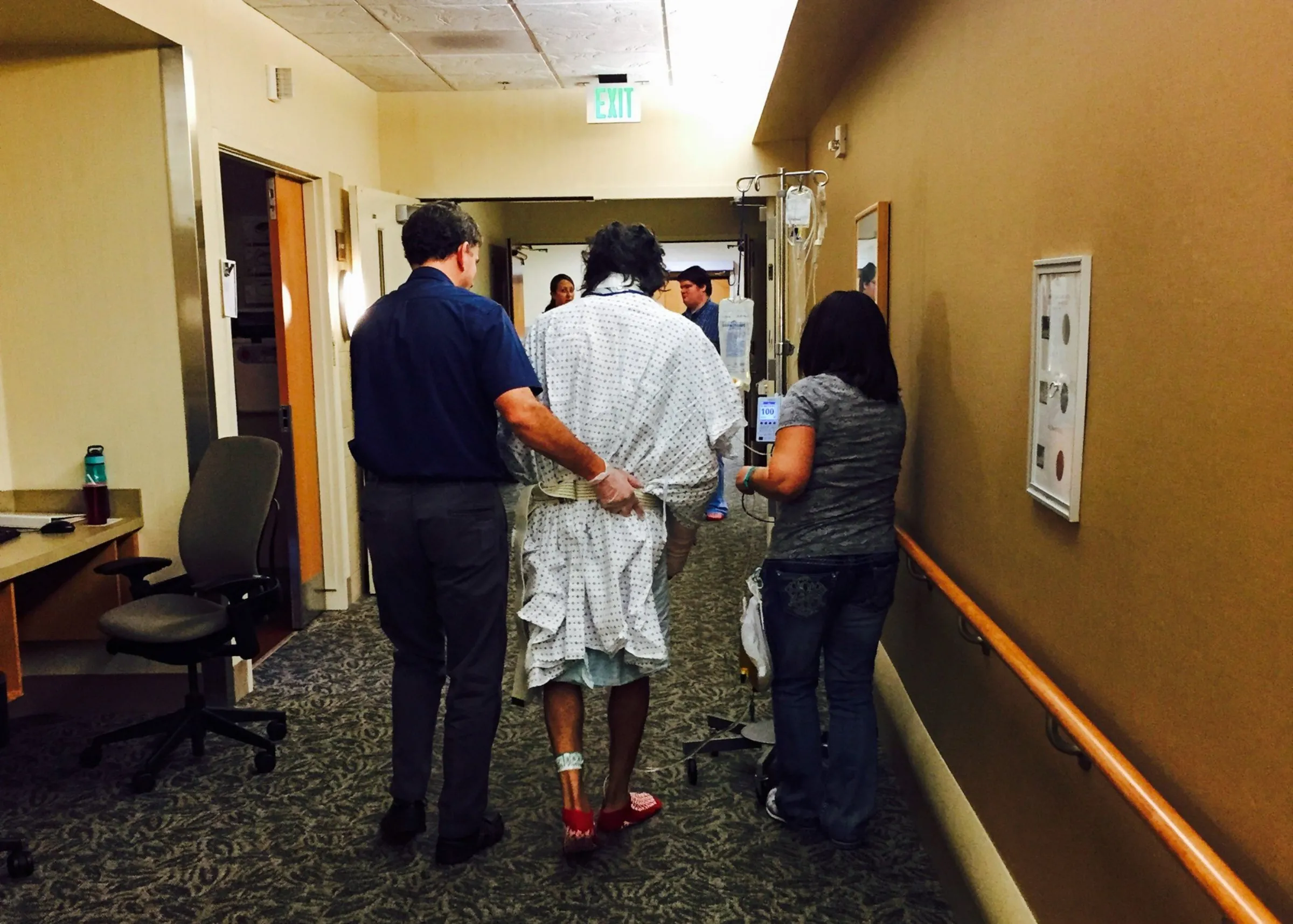 Richard 'Wally' Ochoa walks down a hospital corridor after being hit by a falling tree while defending a small Idaho community from a wildfire, in this undated photo