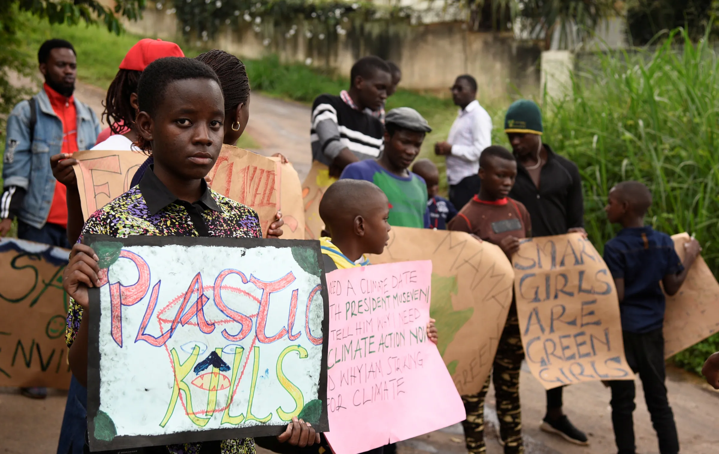 Leah Namugerwa holds a placard as she leads Ugandan students in taking part in the global 'School Strike for Climate' in Kampala, Uganda May 24, 2019