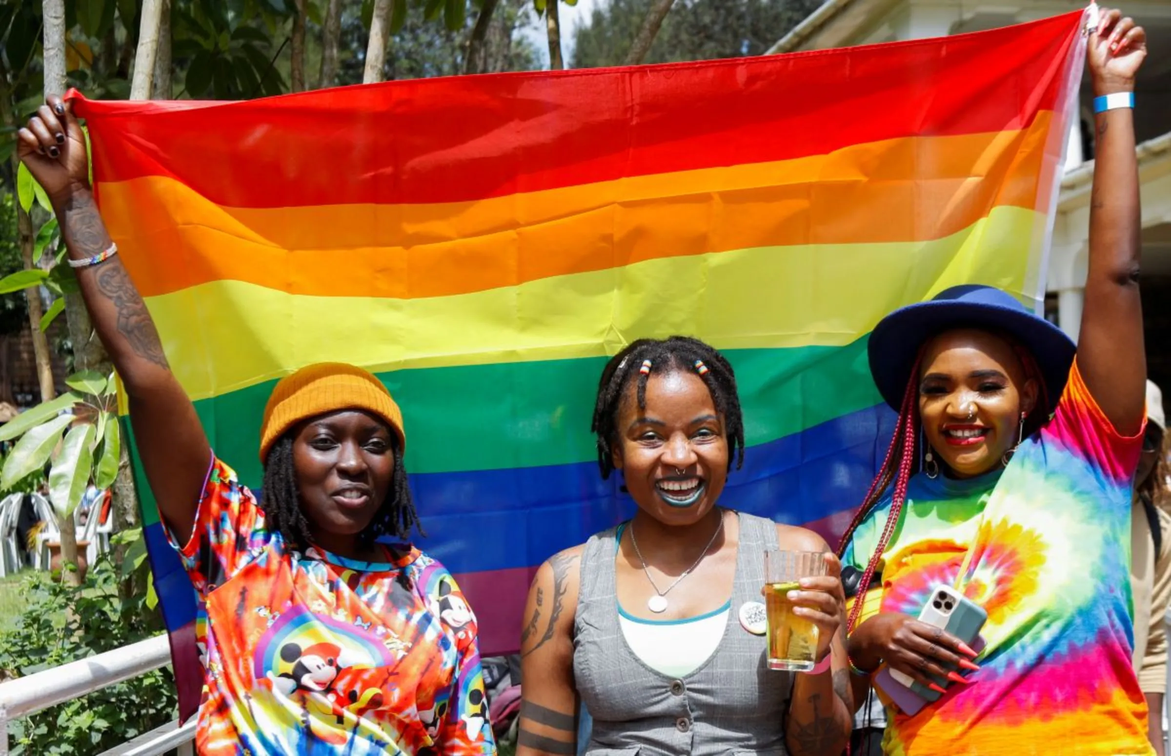 Participants hold a Pride flag as they attend the Badilika festival to celebrate the LGBT rights in Nairobi, Kenya, June 11, 2023. REUTERS/Monicah Mwangi