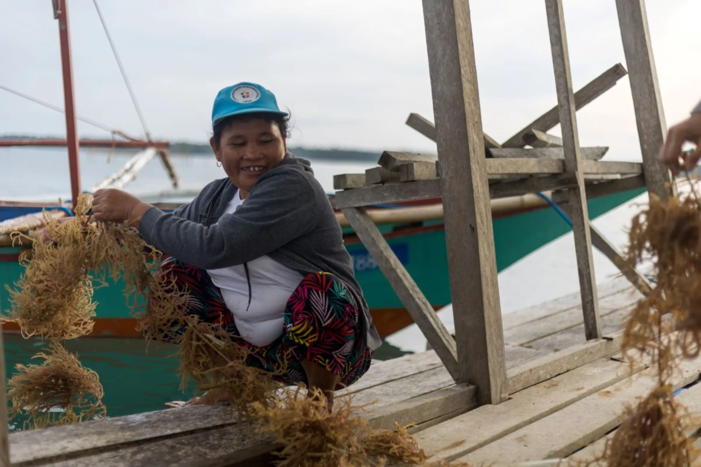 Members of the Cherish Fisherfolk Cooperative in Quezon, Palawan transport seaweeds to their floating dryer. June 5, 2023